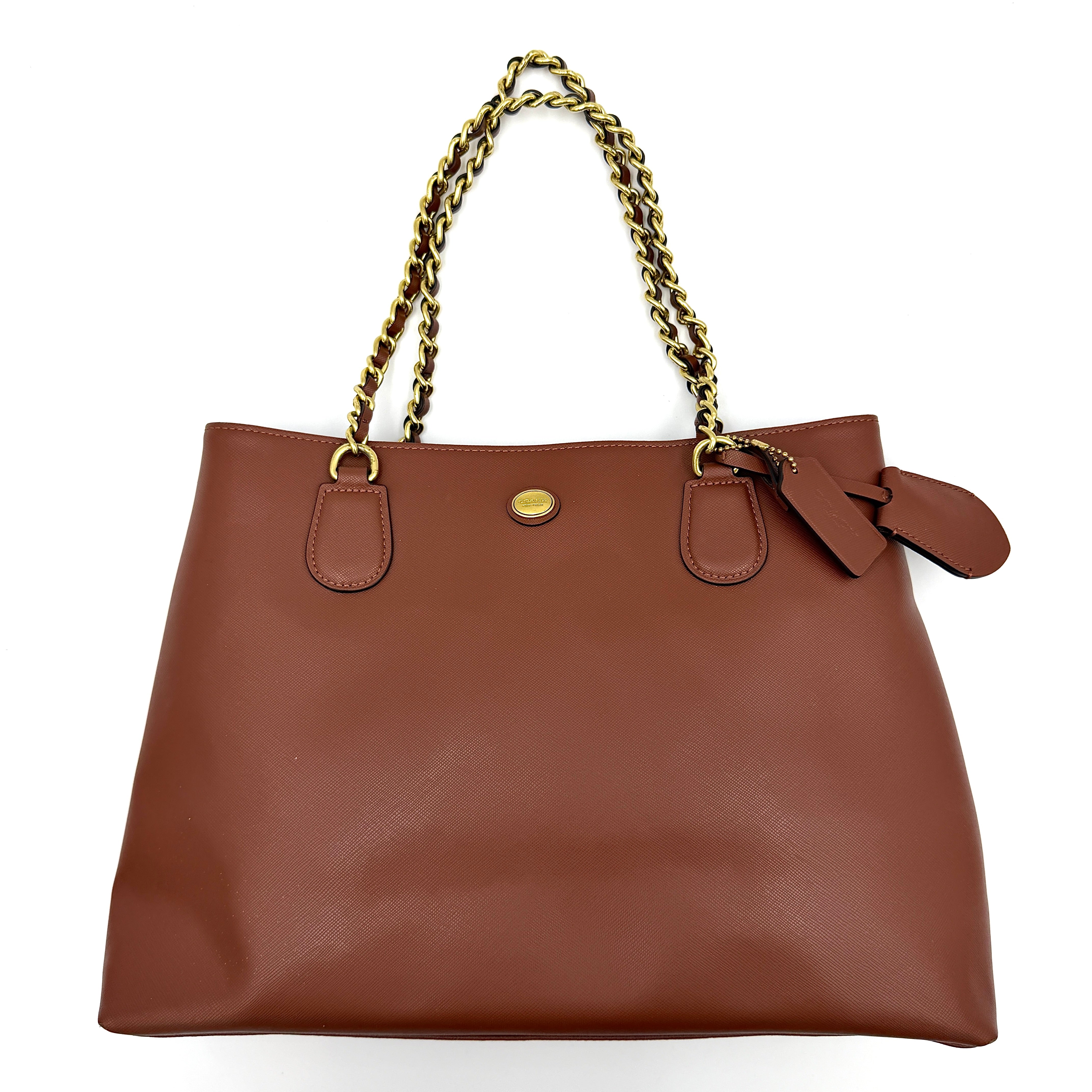 Coach Peyton Chain Shoulder Bag in brown leather with gold-tone chain handles, styled against a clean background.