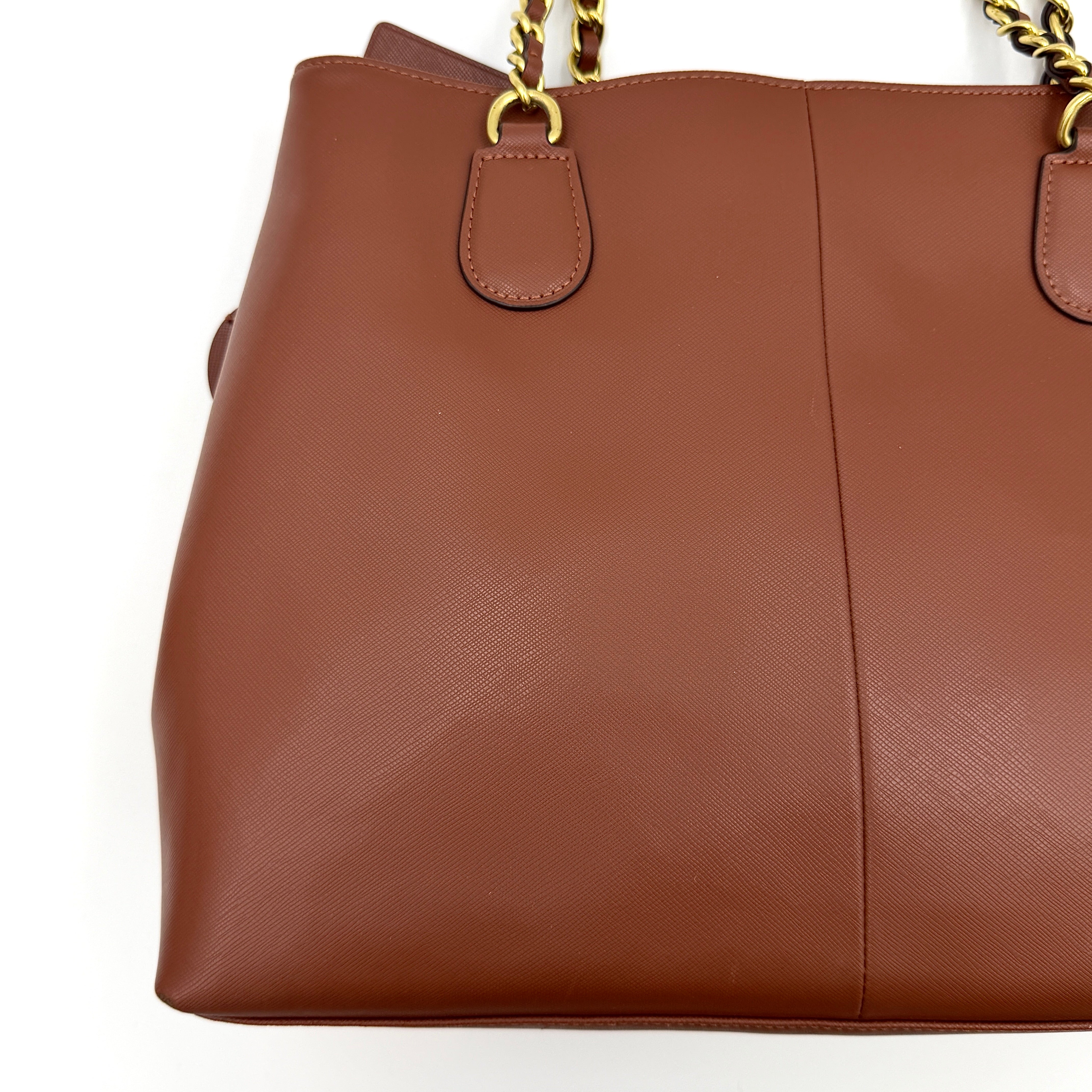 Coach Peyton Chain Shoulder Bag in brown leather with gold-tone chain handles, styled against a clean background.