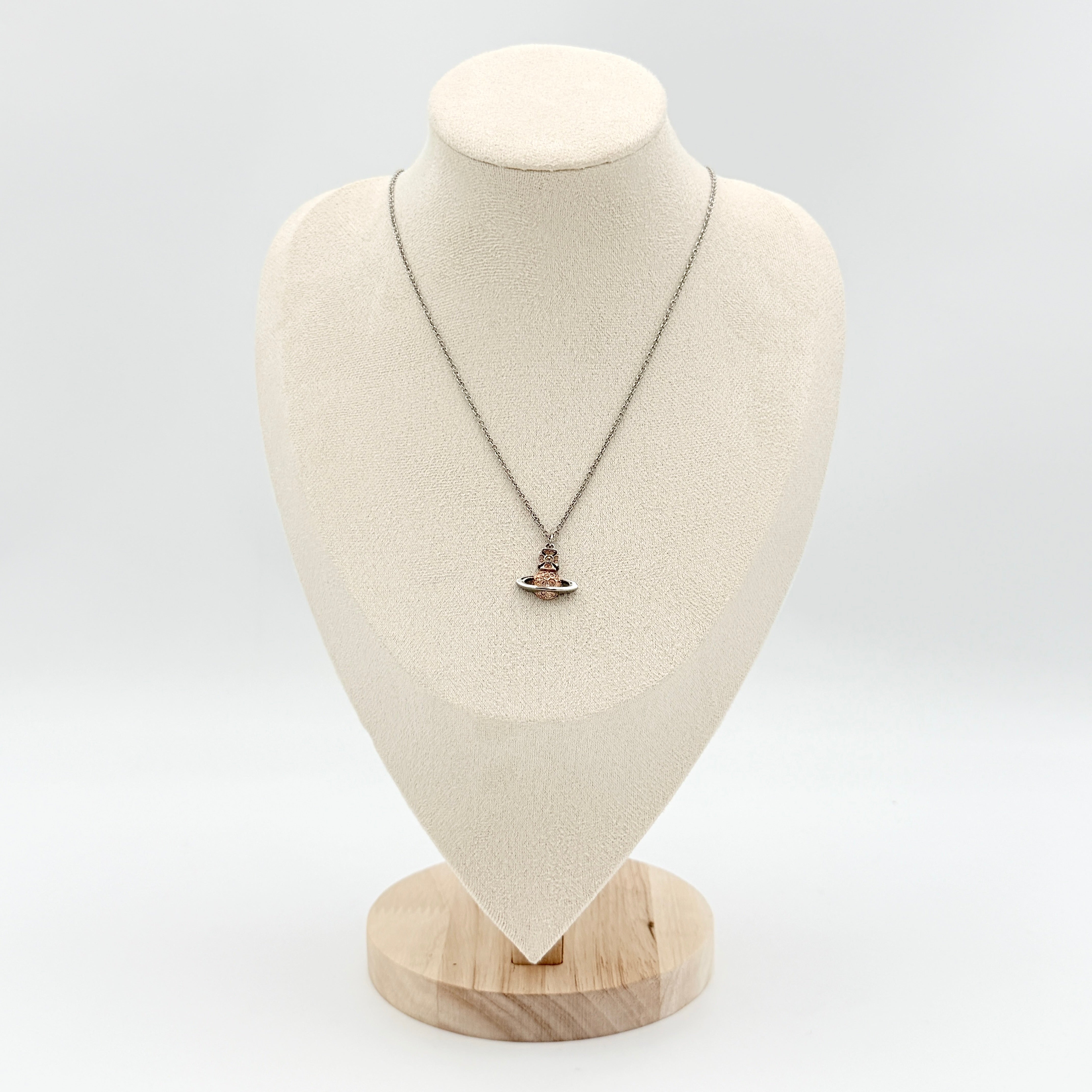 Vivienne Westwood Orb Rhinestone Necklace in silver and rose on display against a neutral bust stand