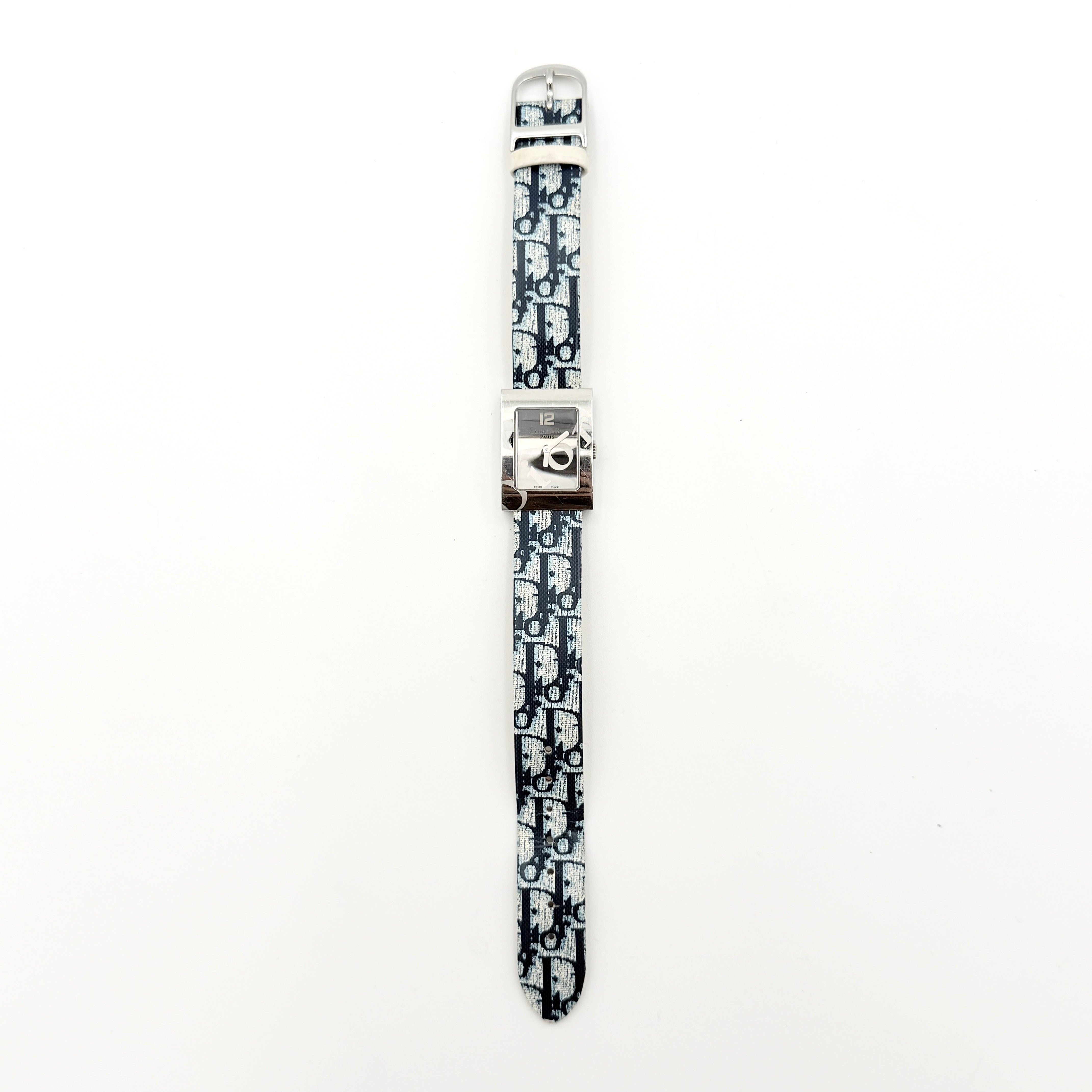 Dior Trotter Malice Watch with blue monogram strap and extra interchangeable yellow and black straps displayed.