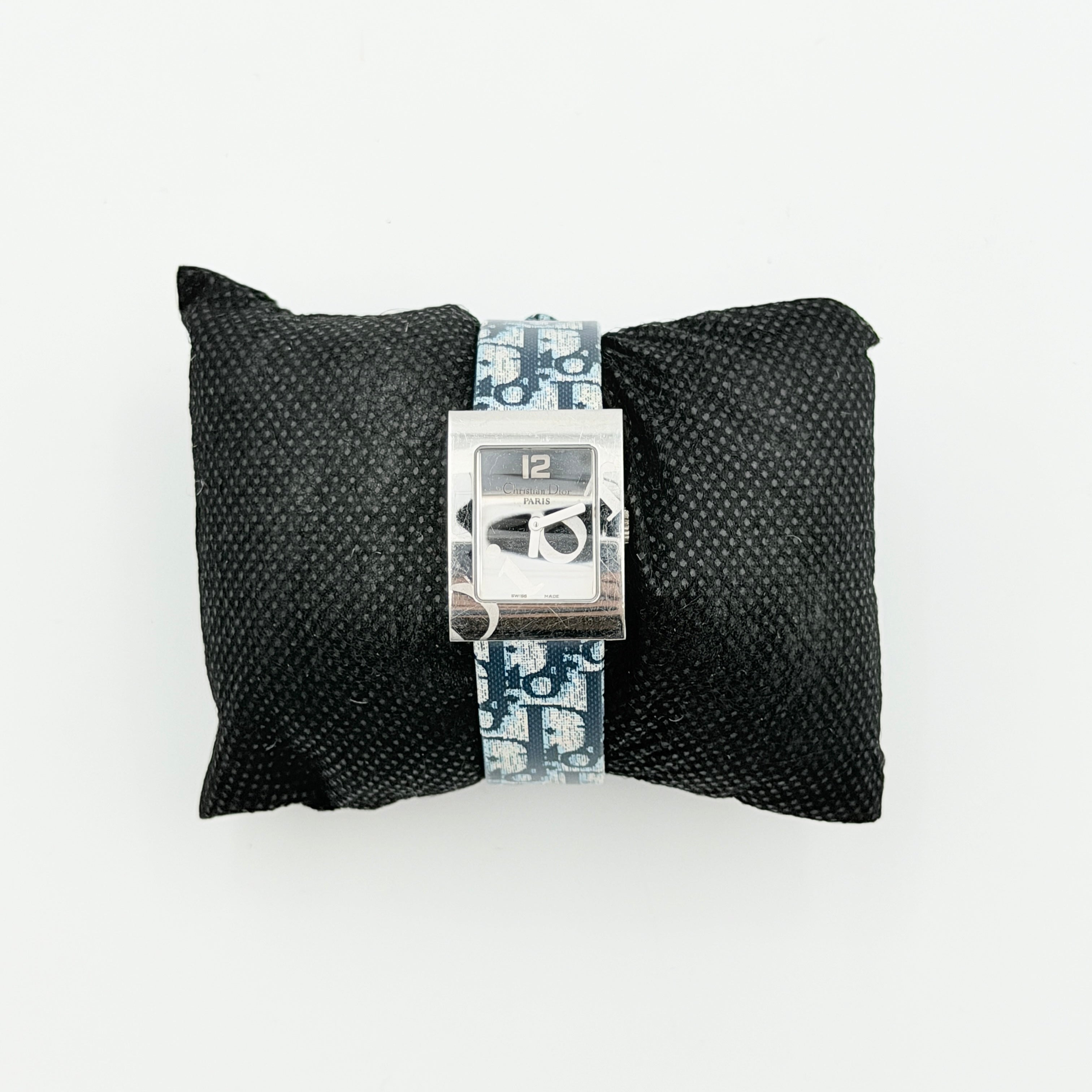 Dior Trotter Malice Watch with blue monogram strap and extra interchangeable yellow and black straps displayed.