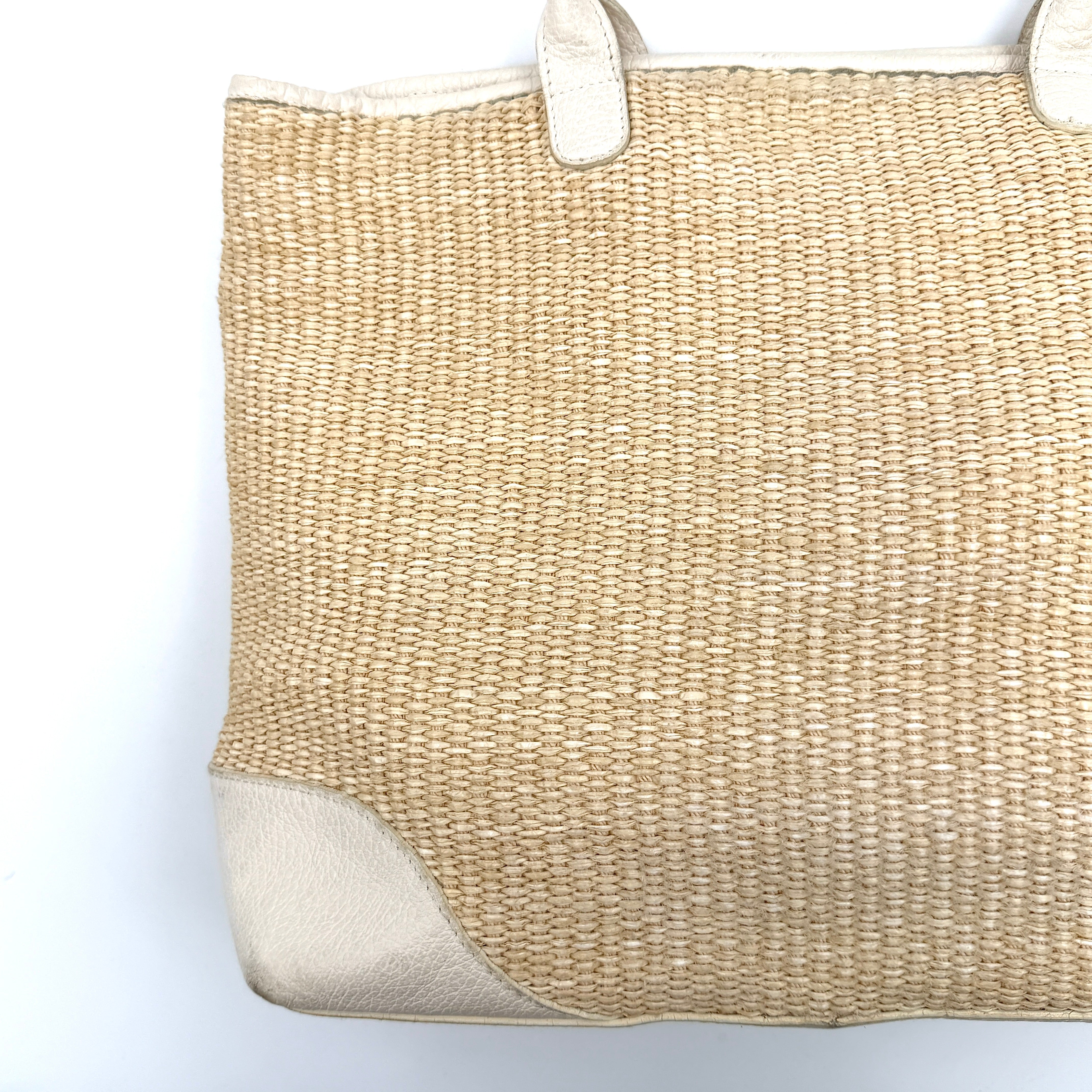 Furla beige woven straw tote bag with off-white leather handles and corners, featuring a silver oval logo plaque.
