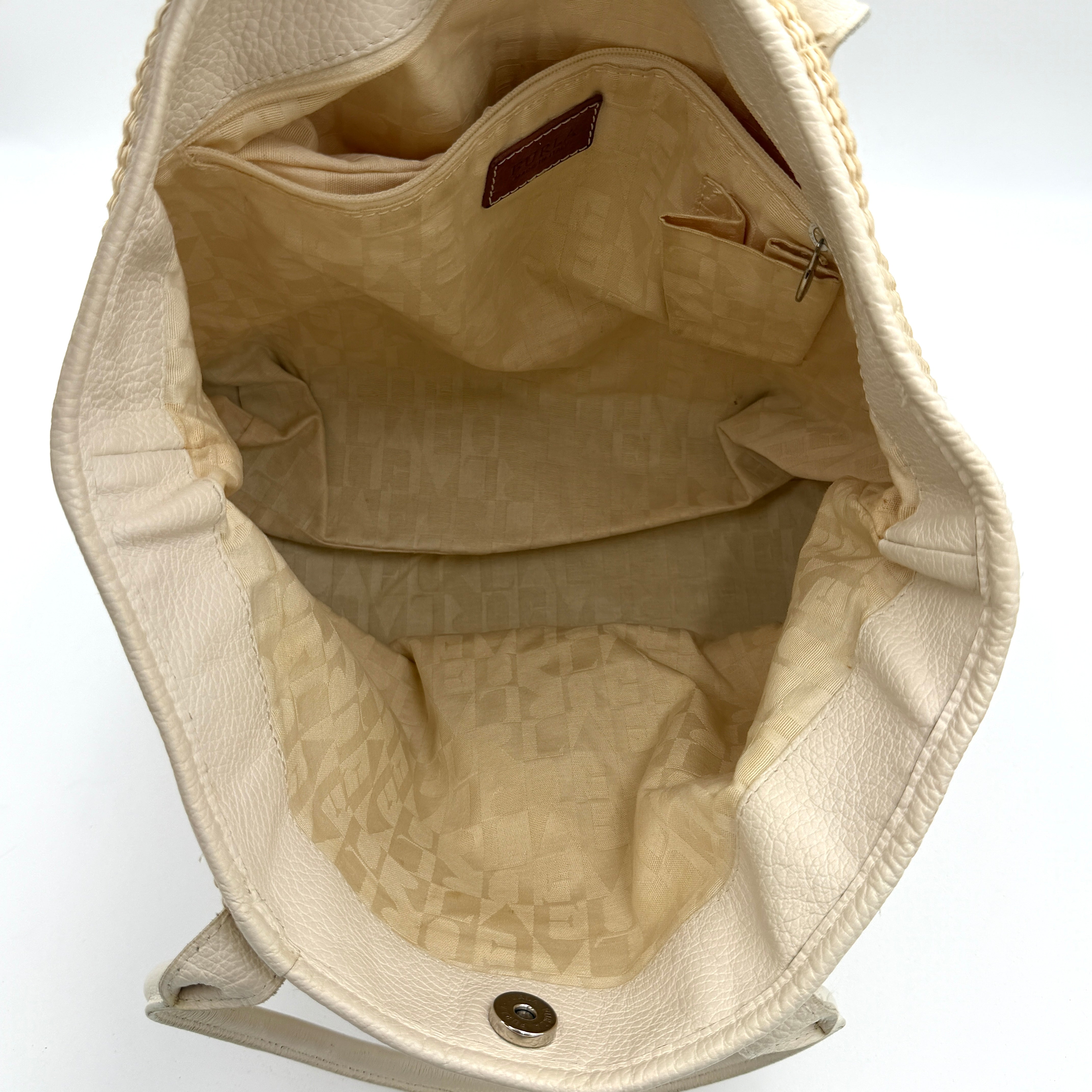Furla beige woven straw tote bag with off-white leather handles and corners, featuring a silver oval logo plaque.
