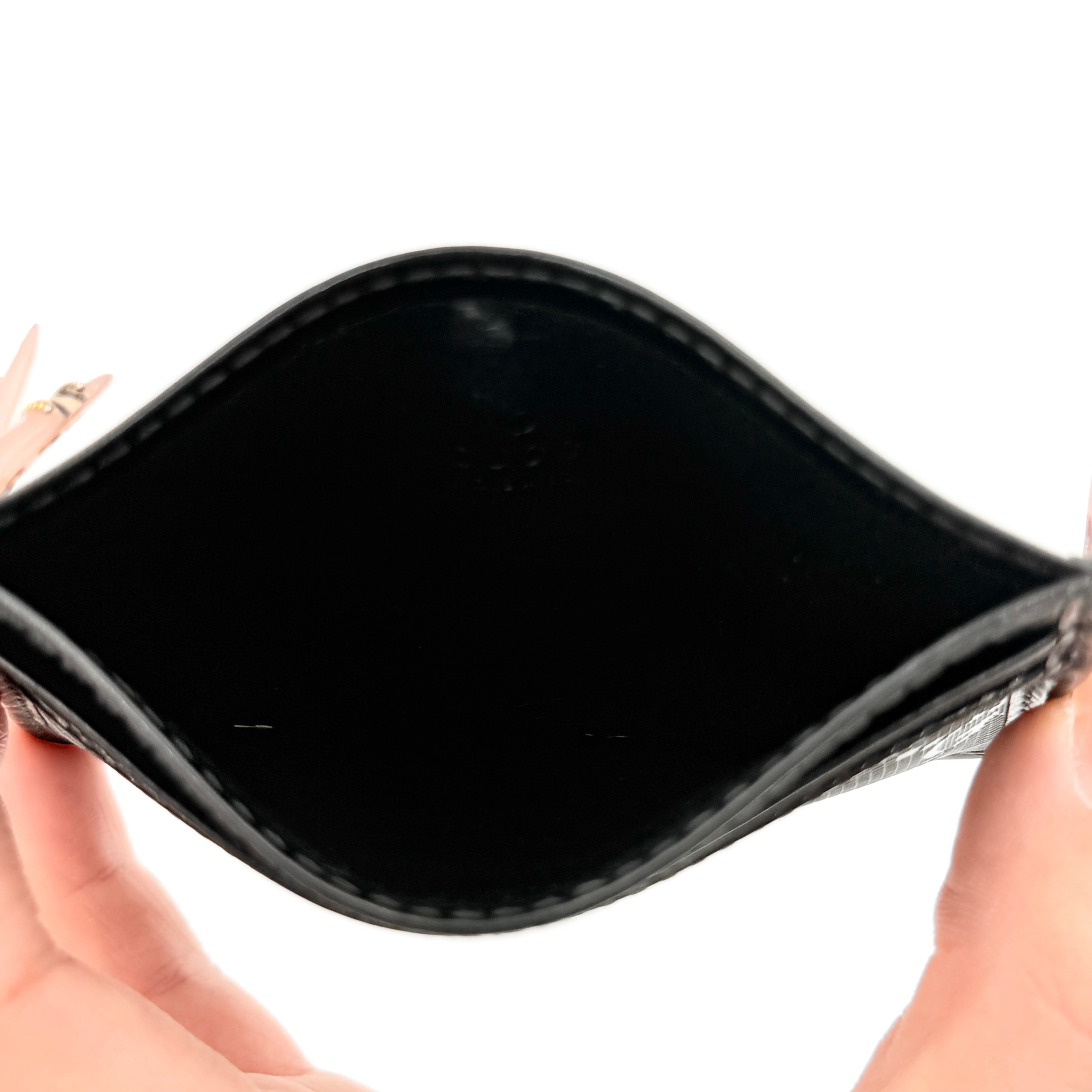 Gucci GG Monogram card holder in black canvas and leather, featuring tonal logo pattern and four exterior card slots.