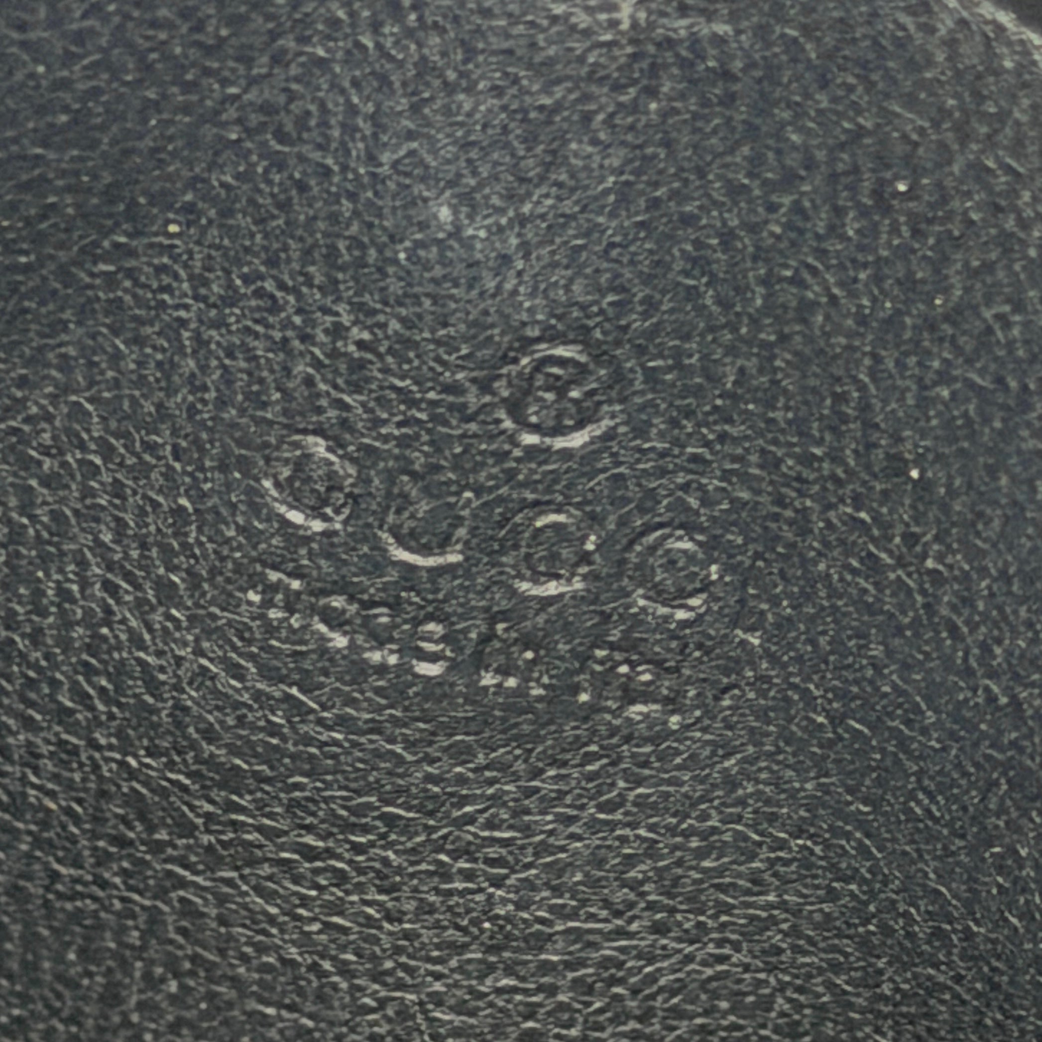 Gucci GG Monogram card holder in black canvas and leather, featuring tonal logo pattern and four exterior card slots.