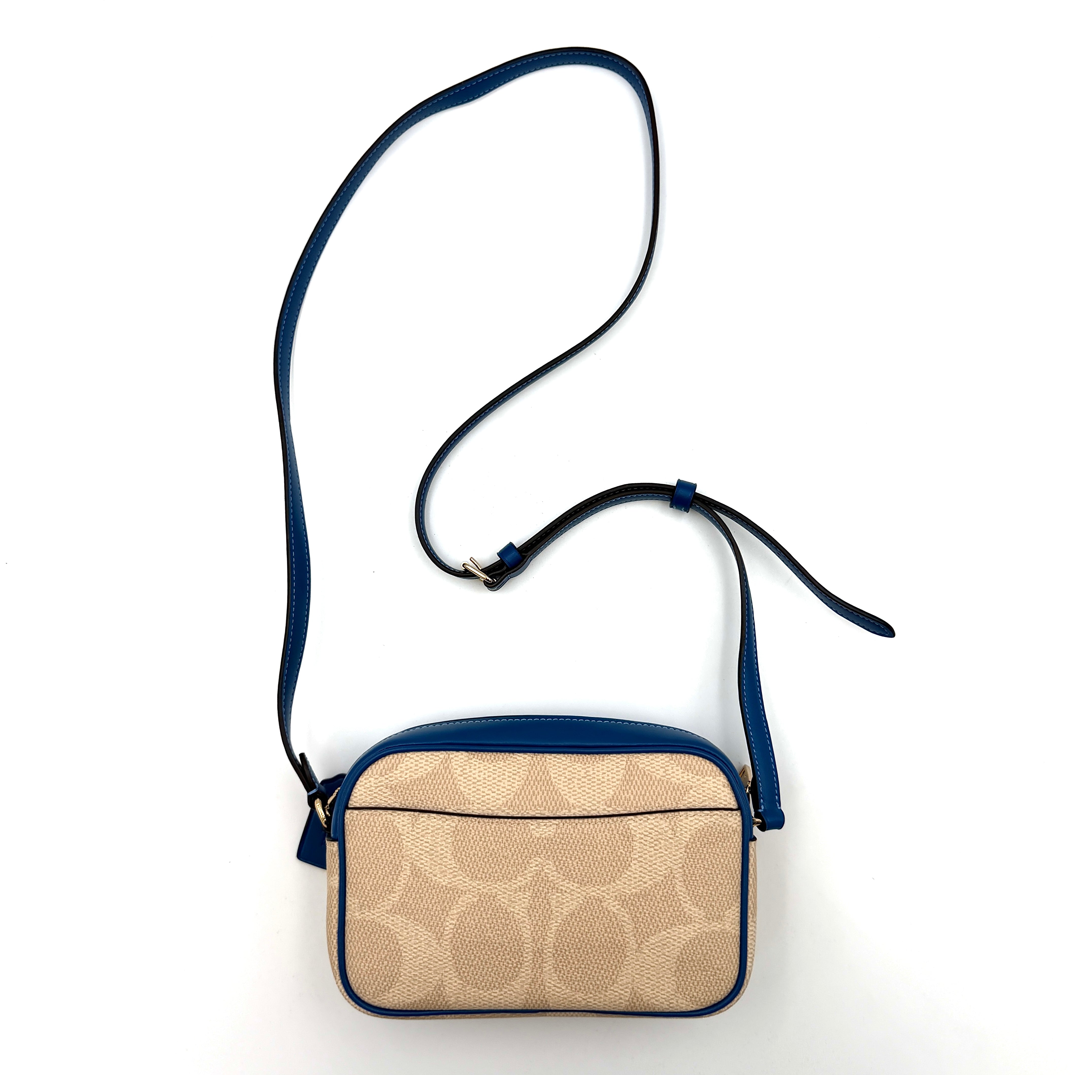 Coach Signature Jamie Camera Crossbody Bag in beige canvas with bold blue logo, cobalt trim, and adjustable blue leather strap.