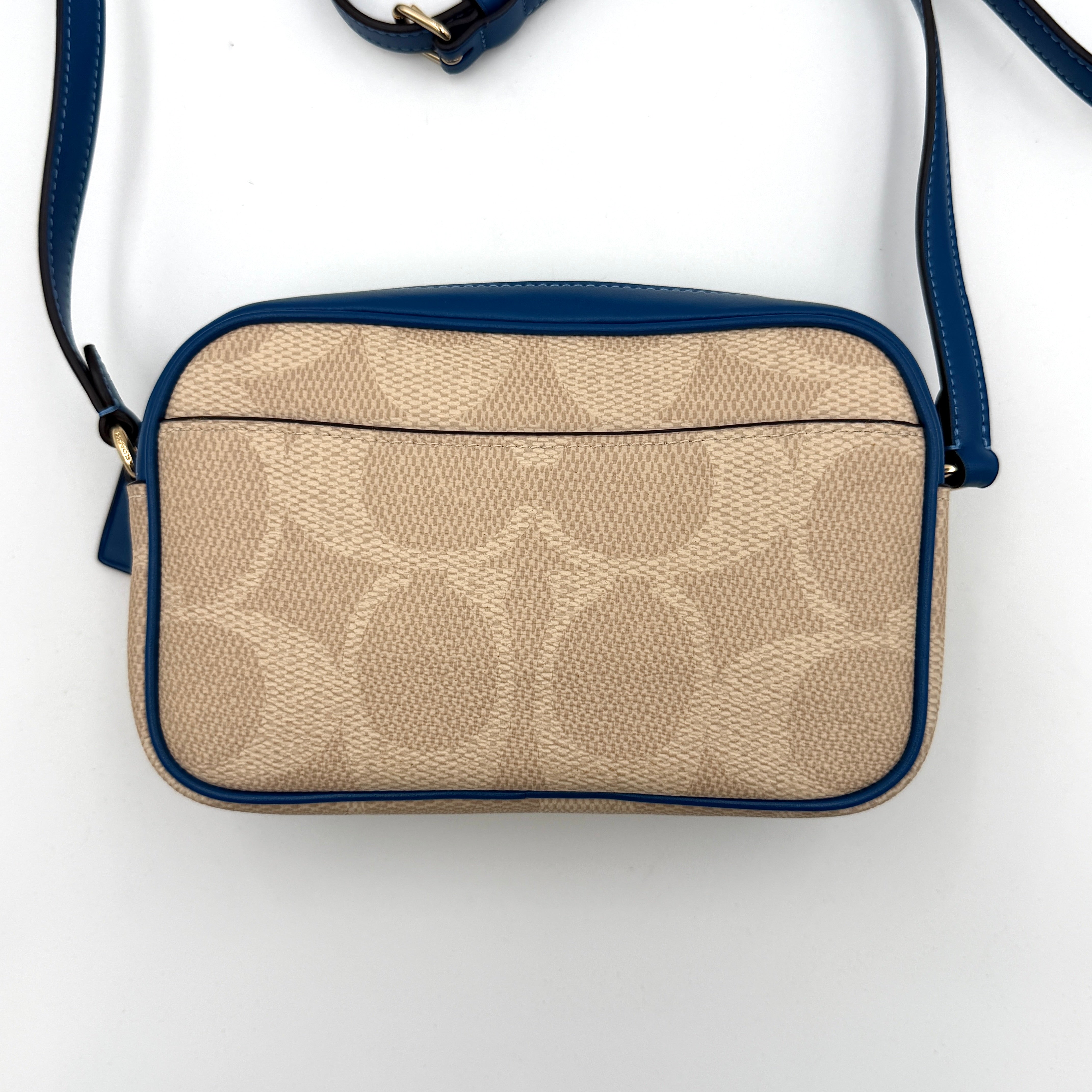 Coach Signature Jamie Camera Crossbody Bag in beige canvas with bold blue logo, cobalt trim, and adjustable blue leather strap.