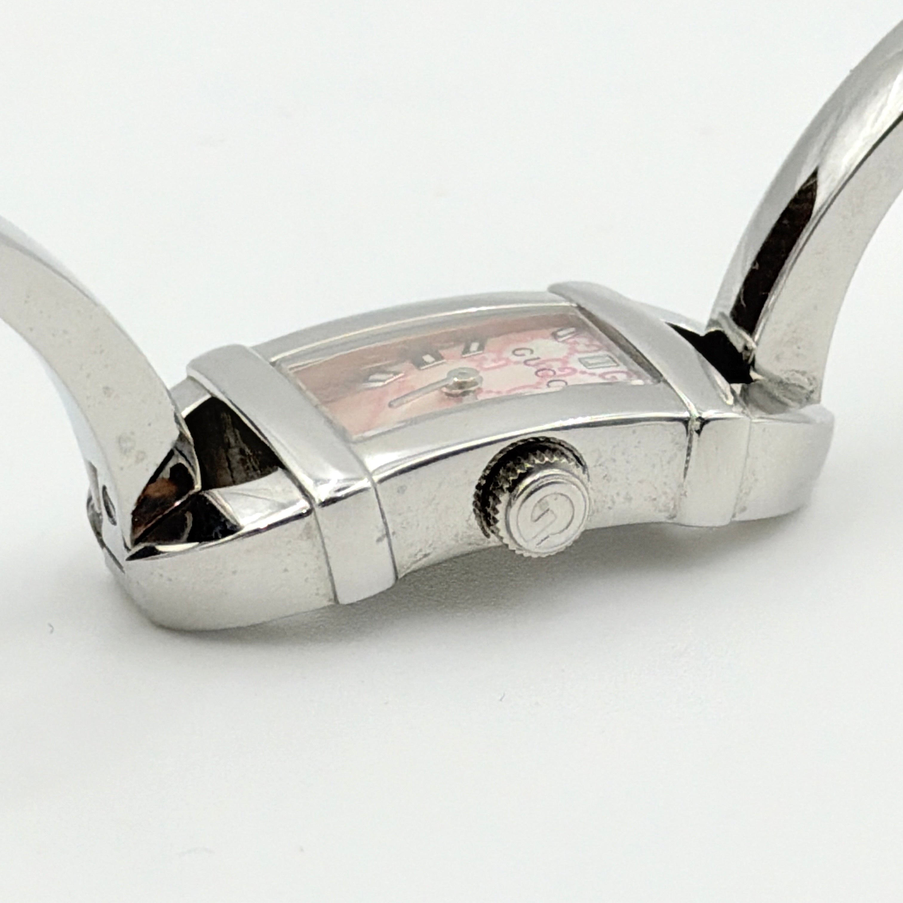 Gucci 6800L GG Bangle Watch in stainless steel with a pink monogram dial, displayed in its original box with branded booklet.