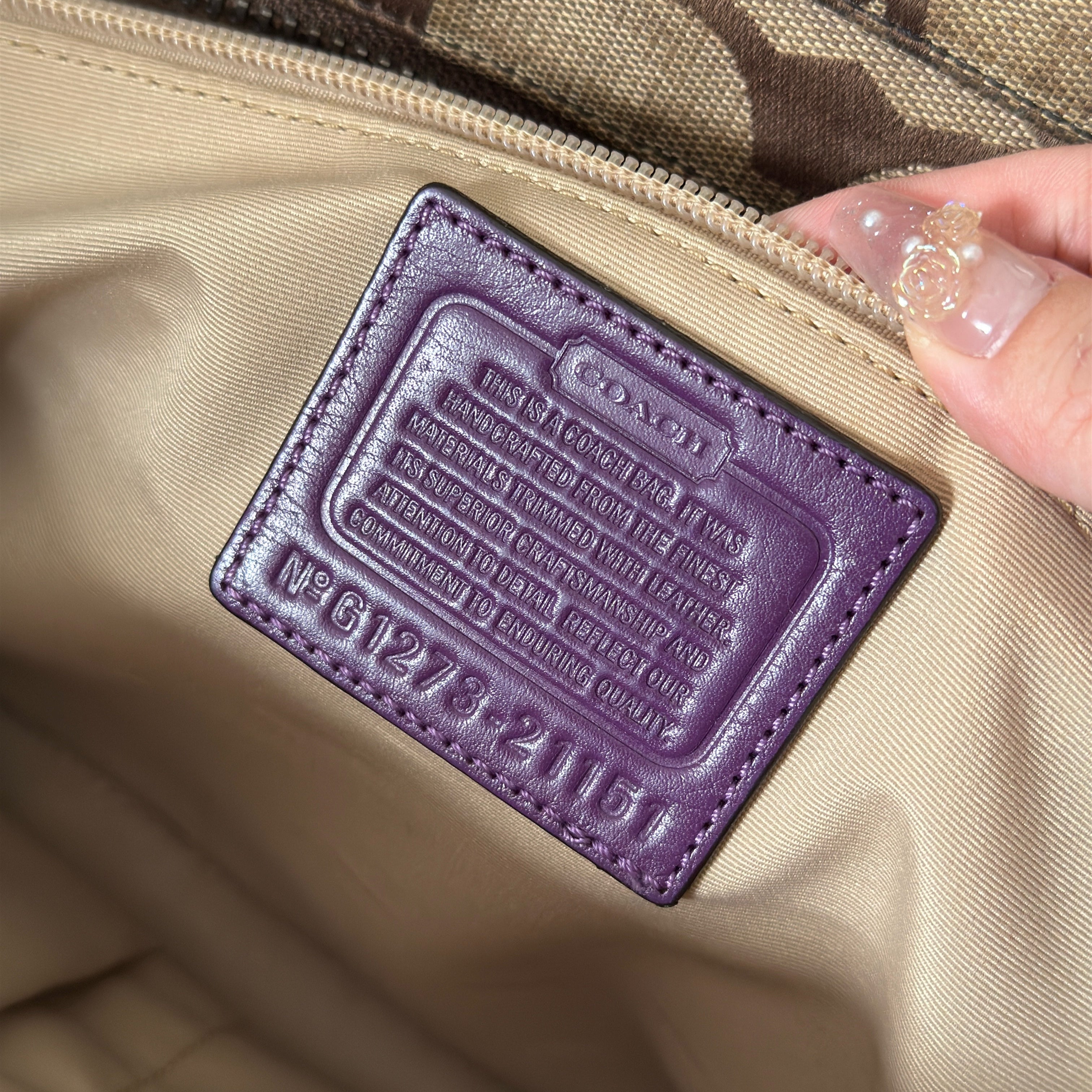 Coach Signature Legacy Candace Carry-All handbag in beige coated canvas with monogram print, purple leather trim, silver-tone hardware, and tassel details.