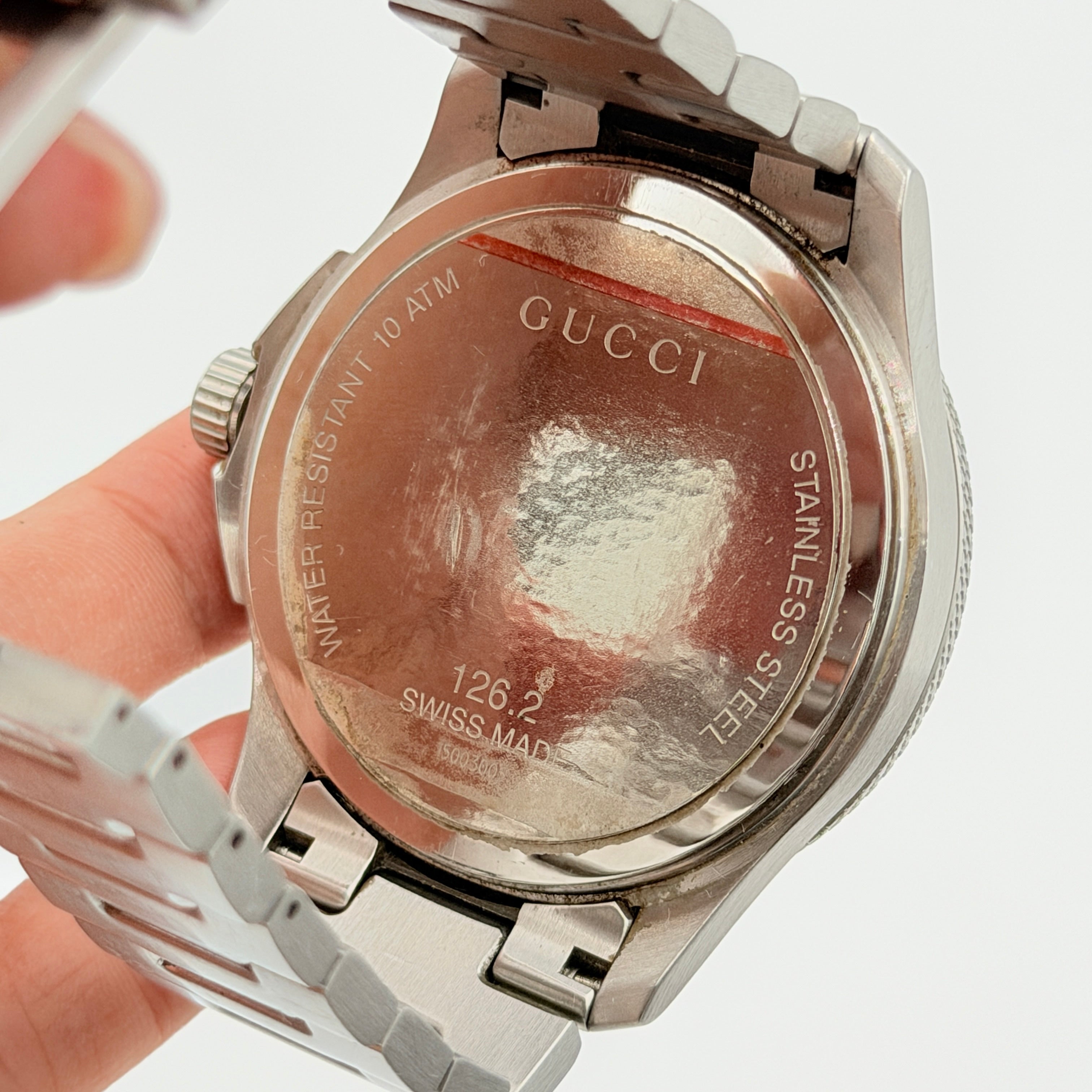 Gucci G-Timeless Sport Watch in silver with black dial, presented in its original box with booklet and extra links.