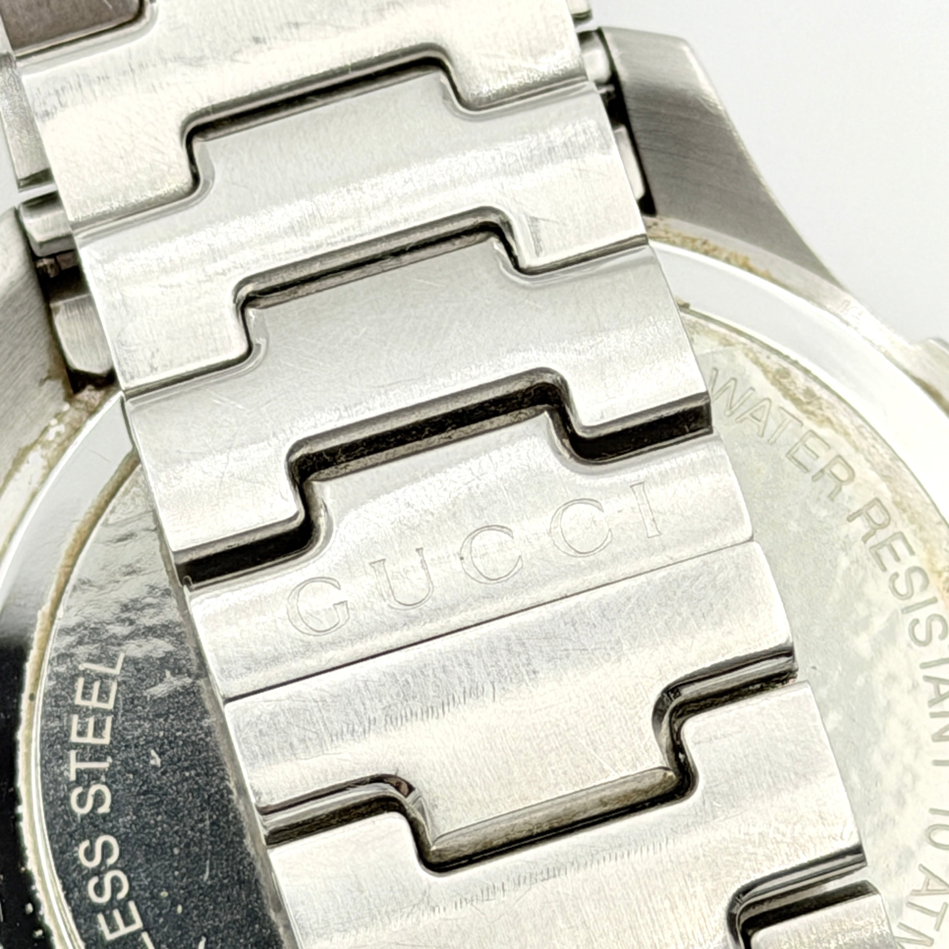 Gucci G-Timeless Sport Watch in silver with black dial, presented in its original box with booklet and extra links.