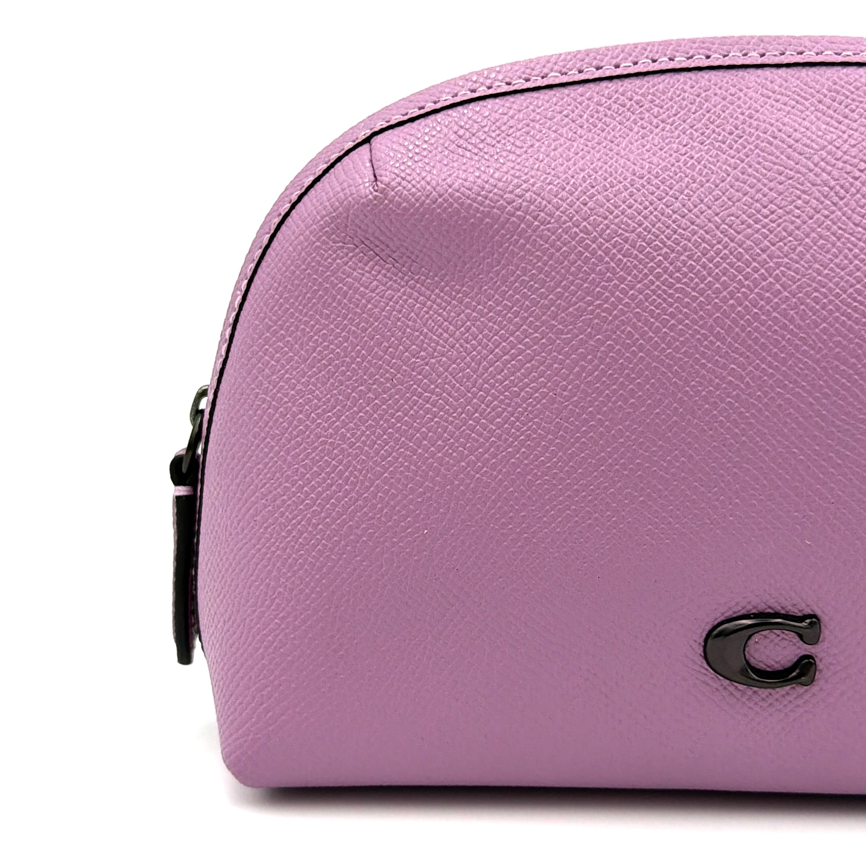 Coach Julienne Cosmetic Case 17 in purple grained leather with black hardware, photographed on a plain background.