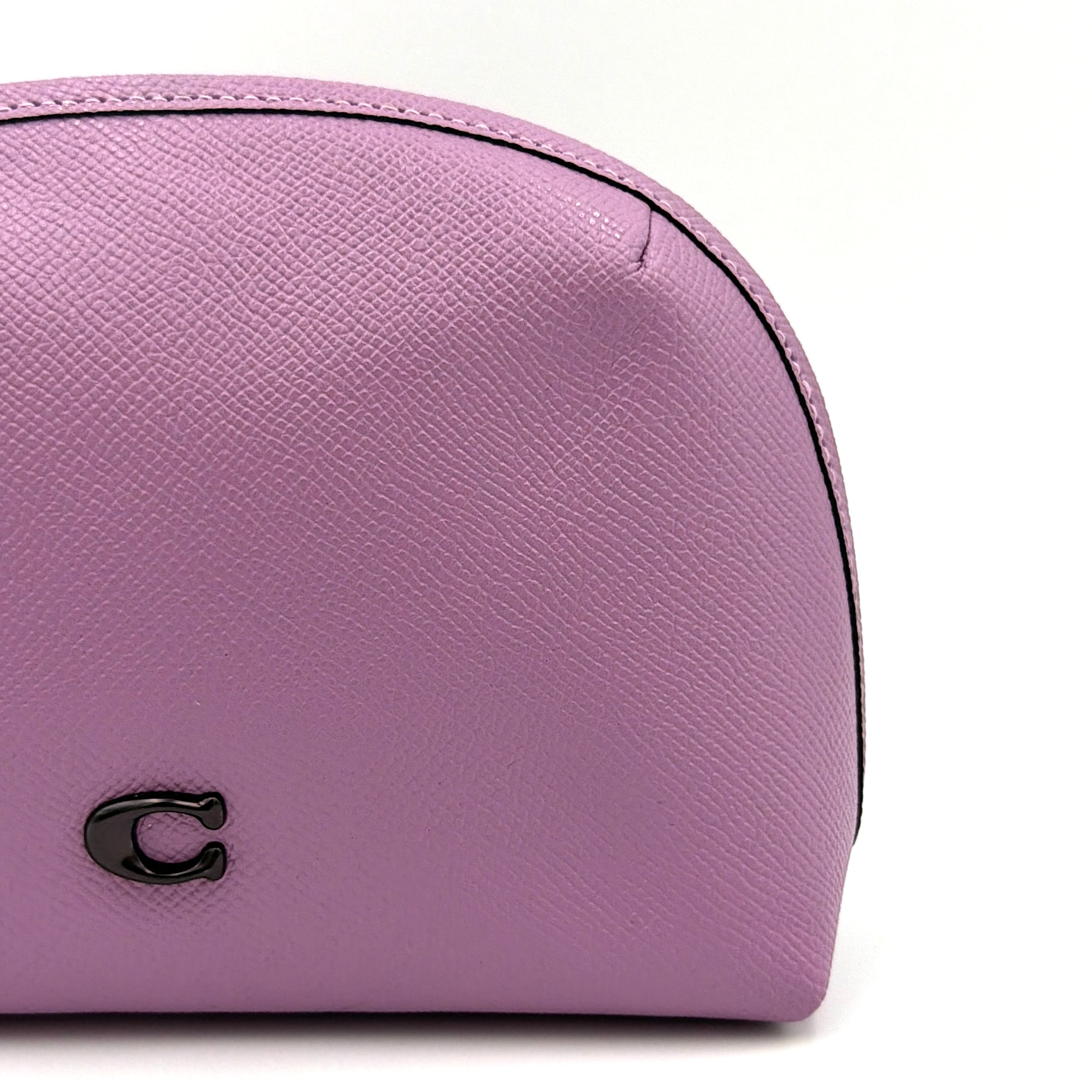 Coach Julienne Cosmetic Case 17 in purple grained leather with black hardware, photographed on a plain background.
