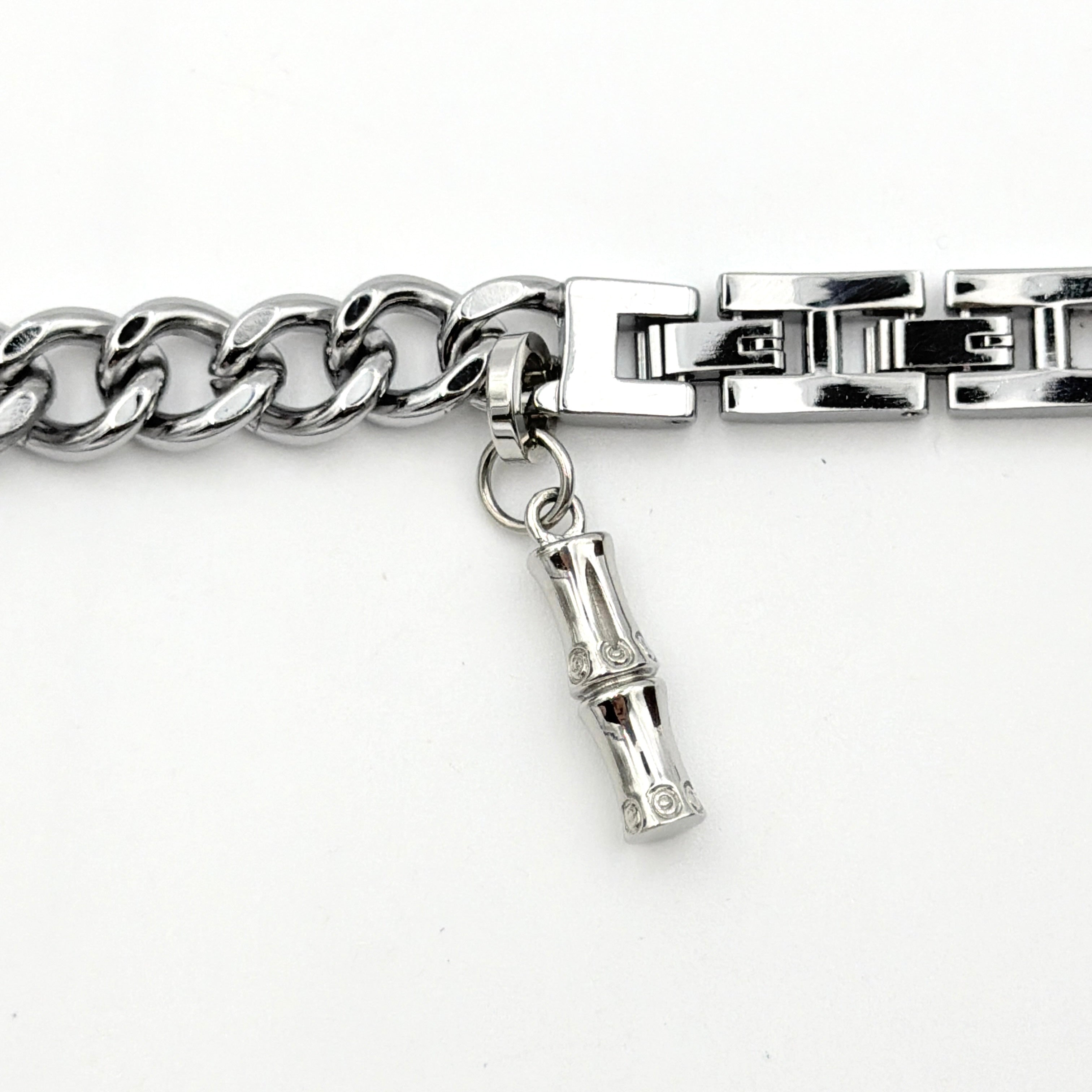 Gucci 107 G Charm Bracelet Watch with silver chunky chain and pink dial, styled on a brown cushion with original Gucci box.