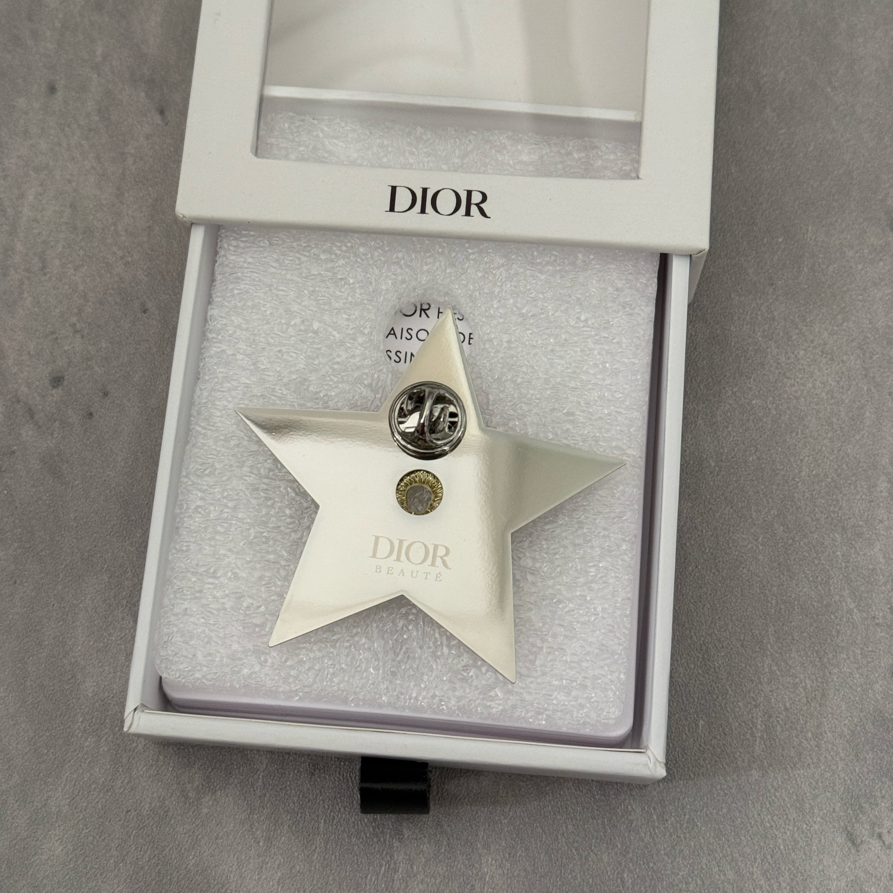 Dior Vintage Star Pin with embroidered gold-tone detailing, silver-tone backing, and original Dior Beauté engraving.