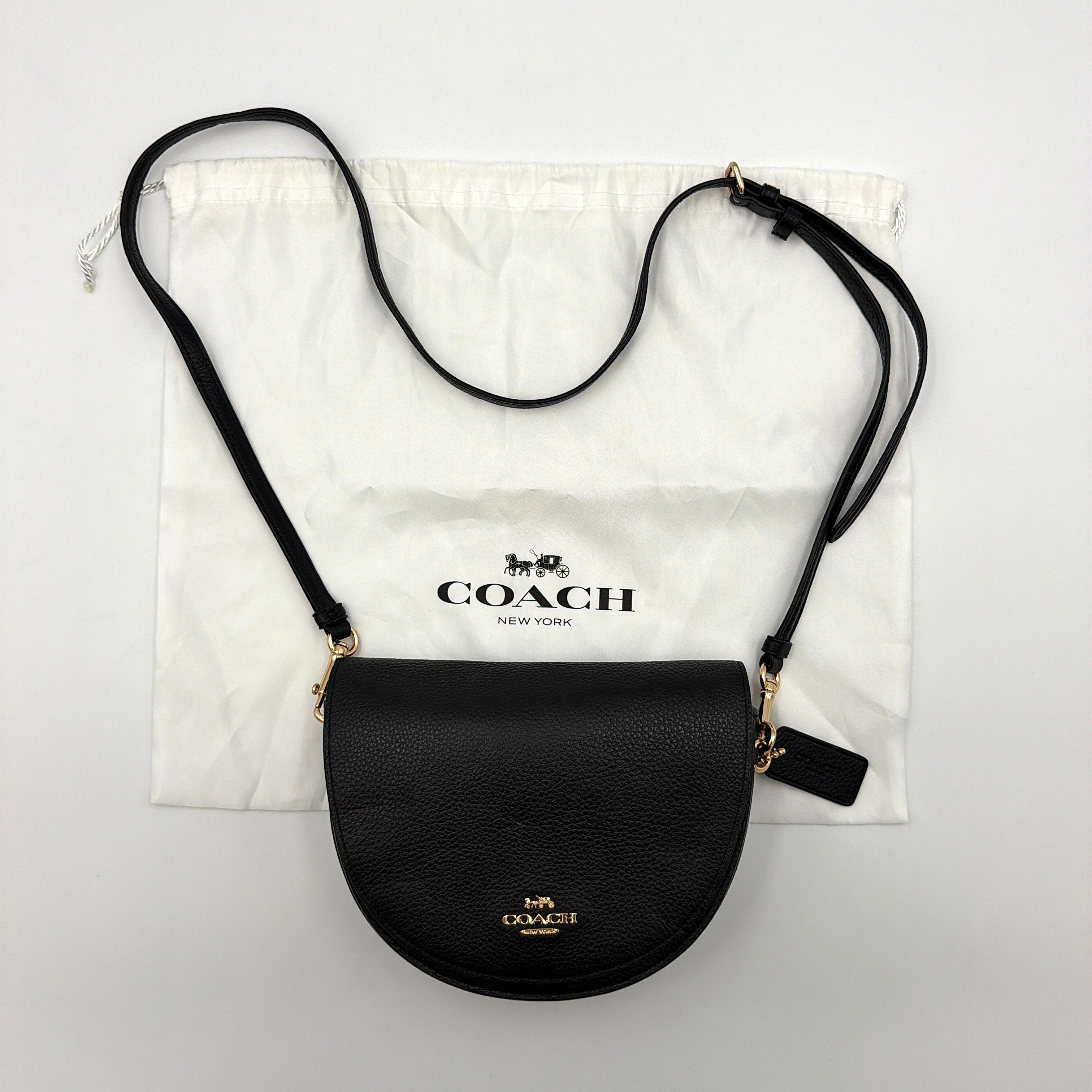 Coach Ellen Crossbody Bag in black pebbled leather with a half-moon silhouette, gold-tone hardware, and adjustable strap.