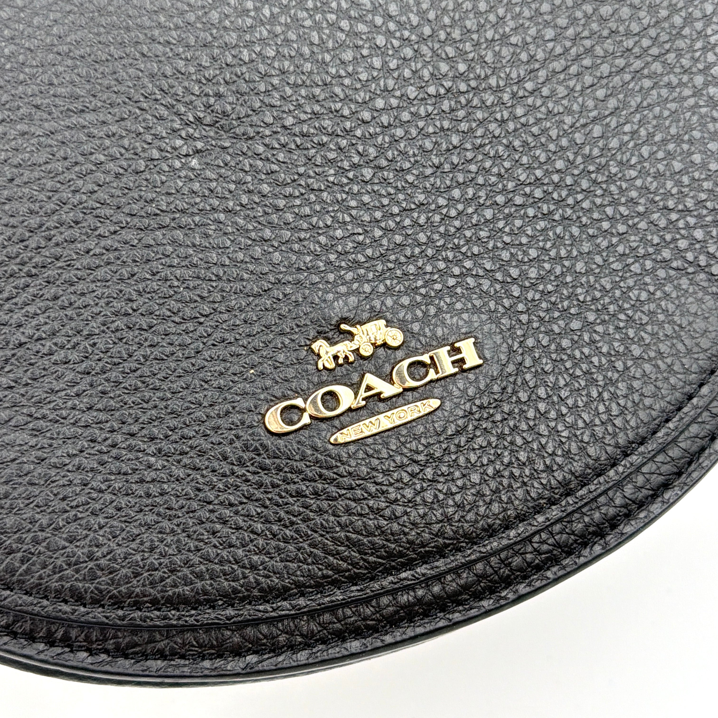 Coach Ellen Crossbody Bag in black pebbled leather with a half-moon silhouette, gold-tone hardware, and adjustable strap.