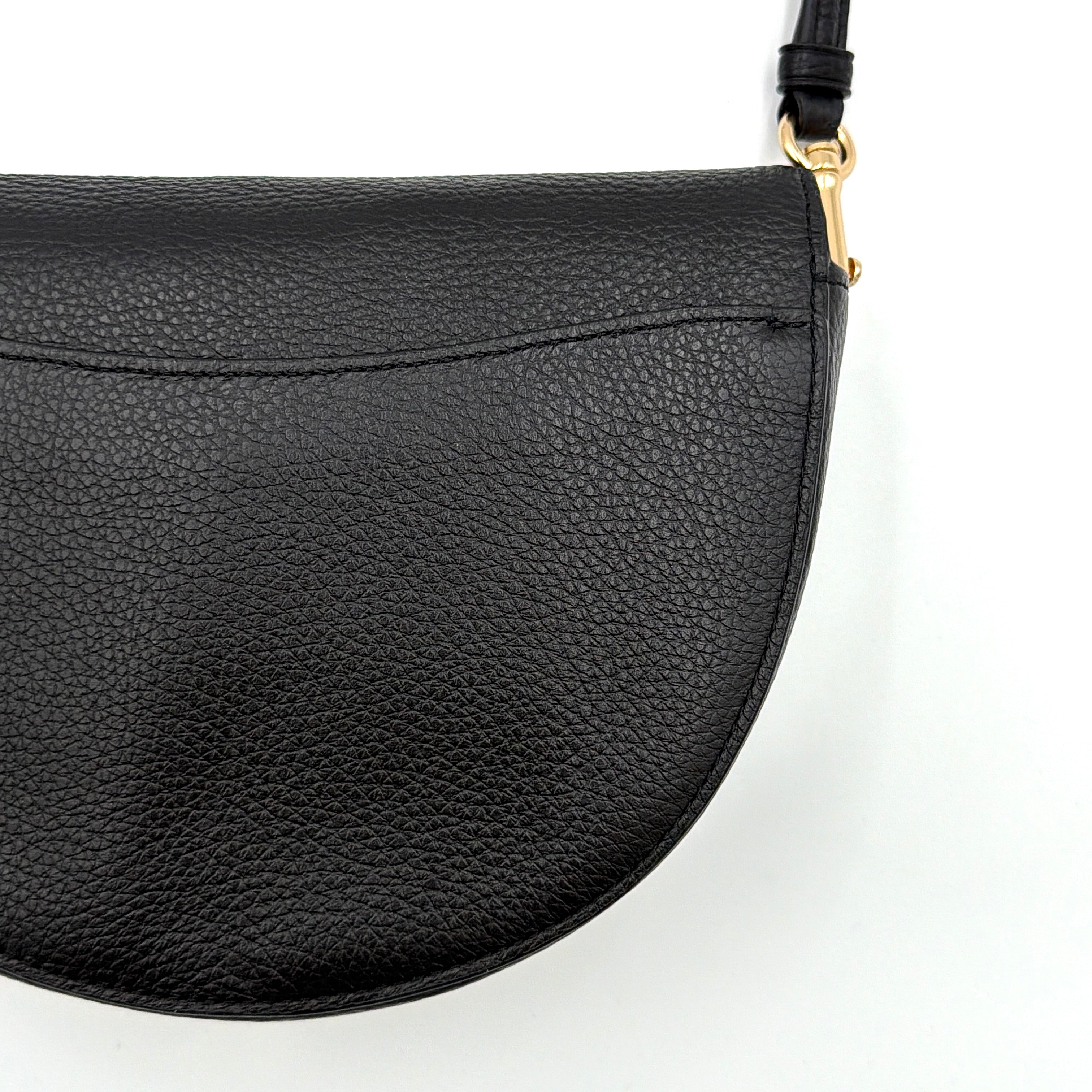 Coach Ellen Crossbody Bag in black pebbled leather with a half-moon silhouette, gold-tone hardware, and adjustable strap.