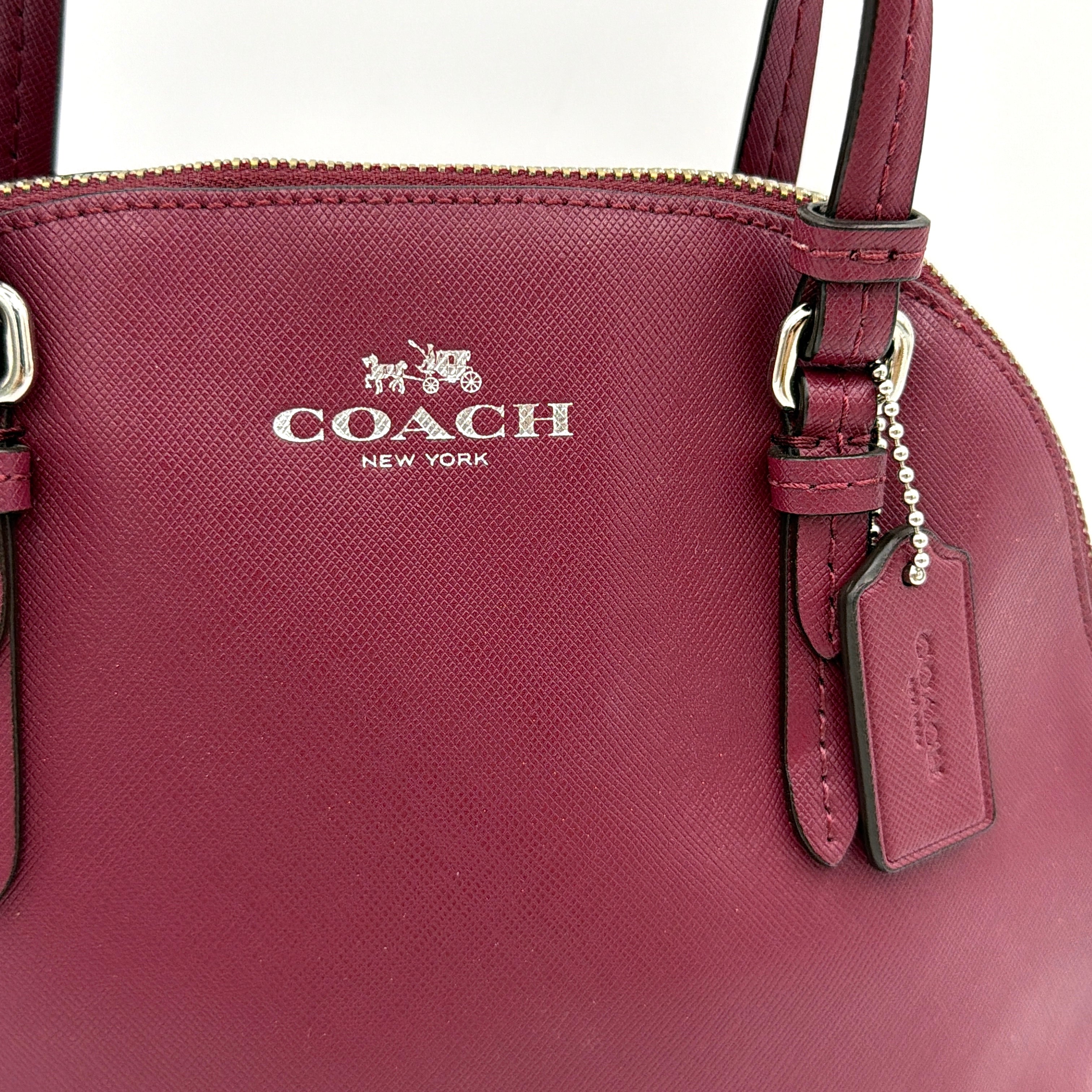 Coach Peyton satchel in burgundy crossgrain leather with silver hardware, shown with its detachable shoulder strap.