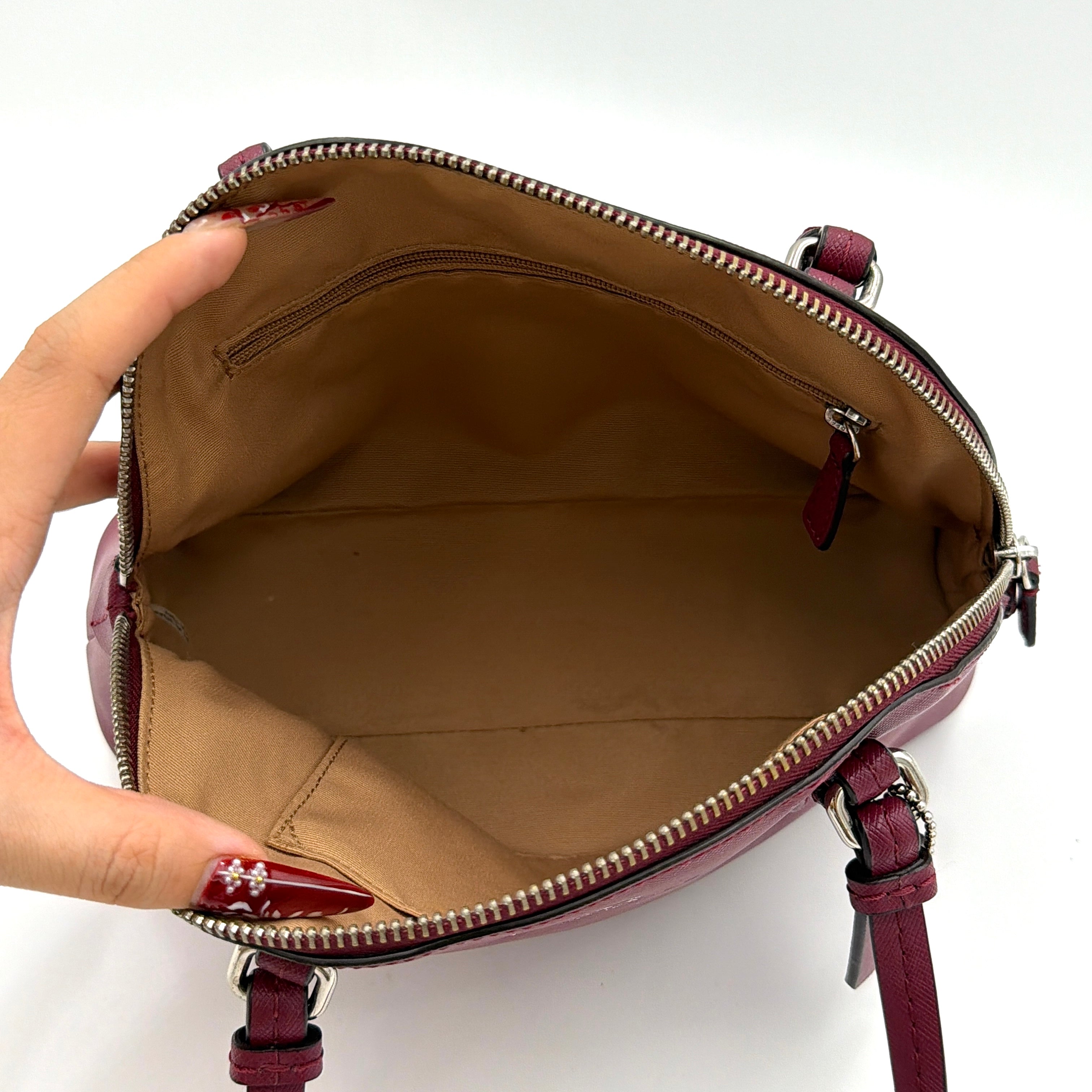 Coach Peyton satchel in burgundy crossgrain leather with silver hardware, shown with its detachable shoulder strap.