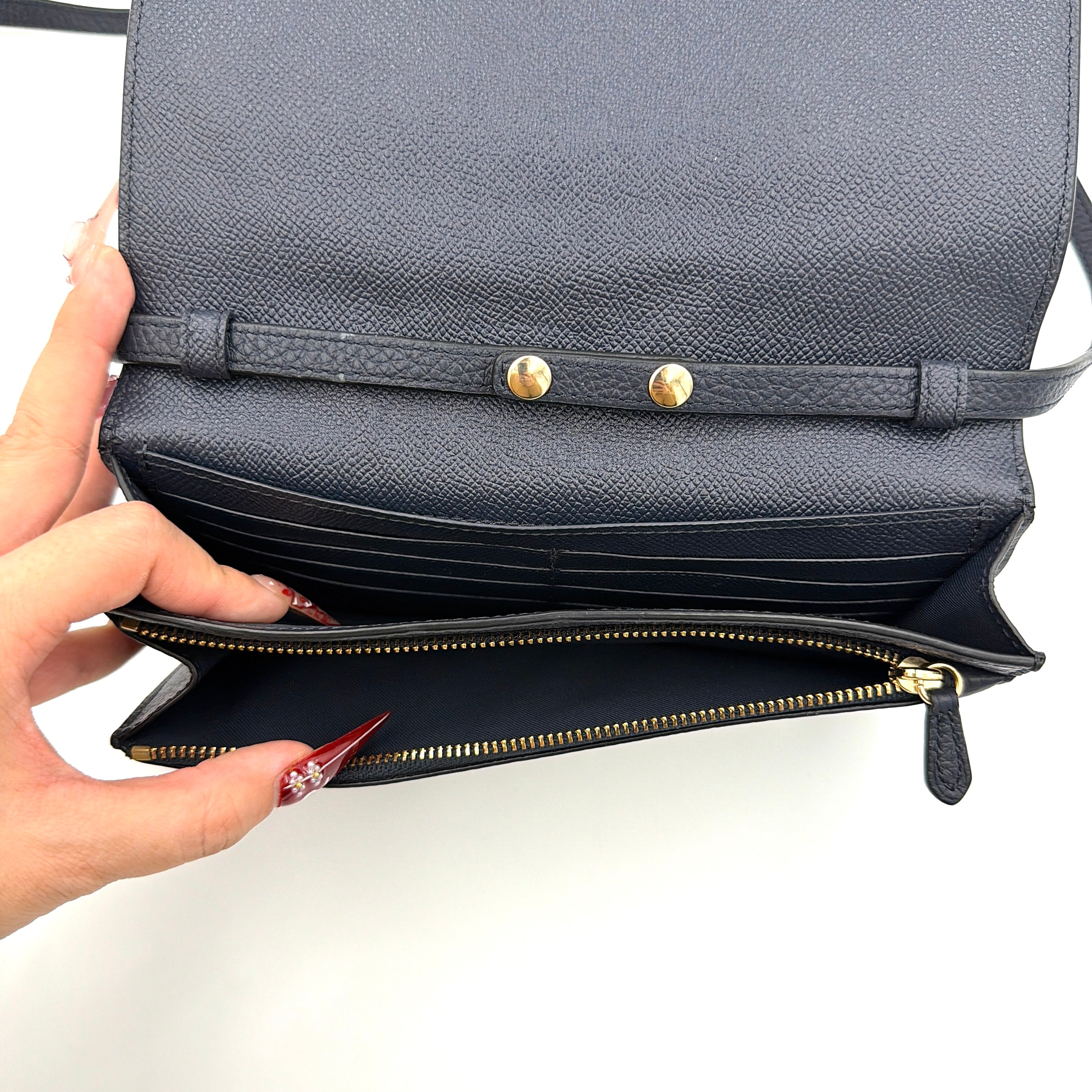 Coach Anna Foldover Clutch Crossbody Bag in navy pebbled leather with slim strap and gold logo detailing.
