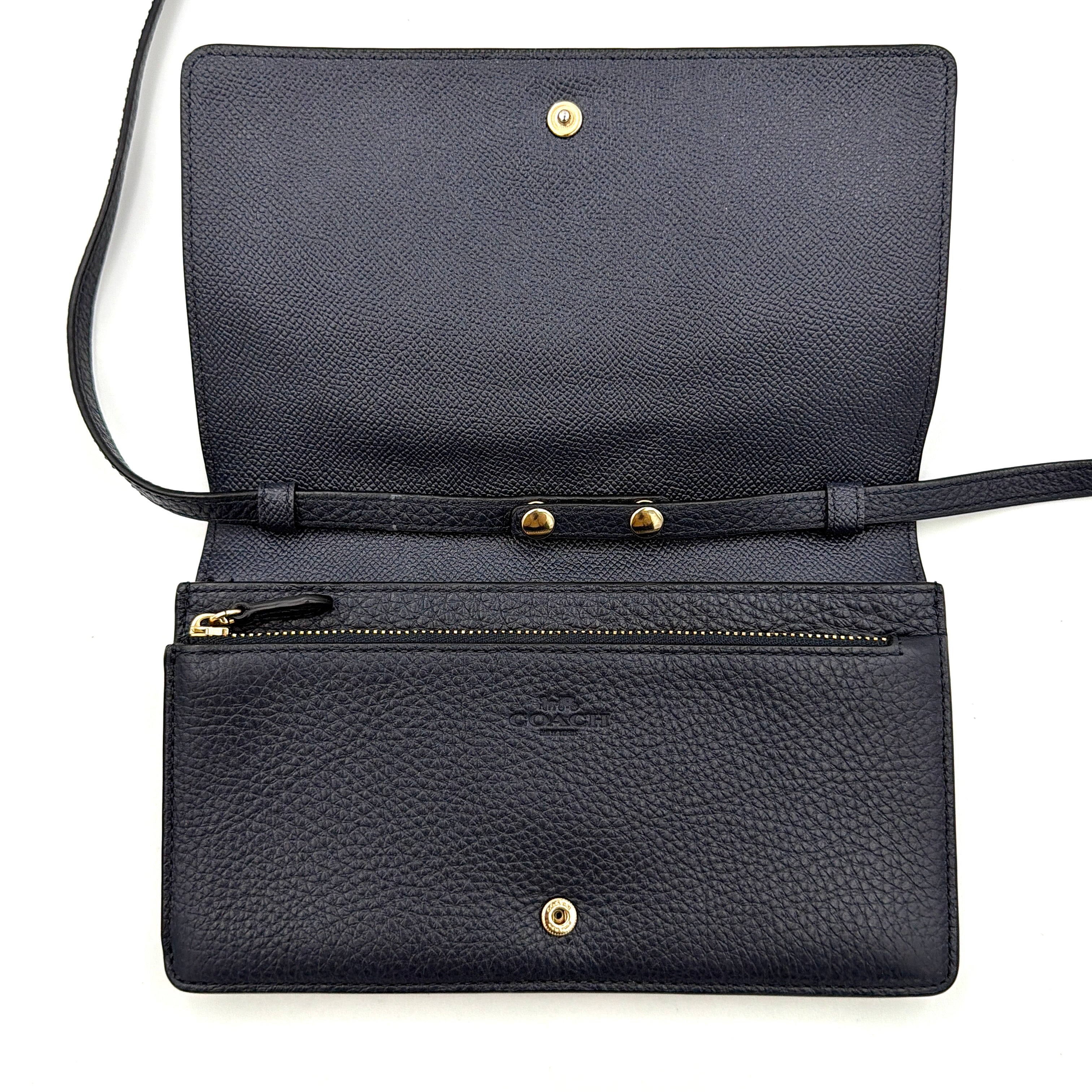 Coach Anna Foldover Clutch Crossbody Bag in navy pebbled leather with slim strap and gold logo detailing.