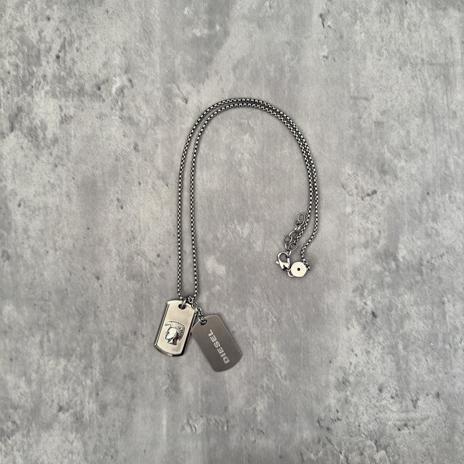 Diesel Double Plate Dog Tag Pendant Necklace in silver-tone stainless steel, featuring a Mohawk head engraving and Diesel logo.