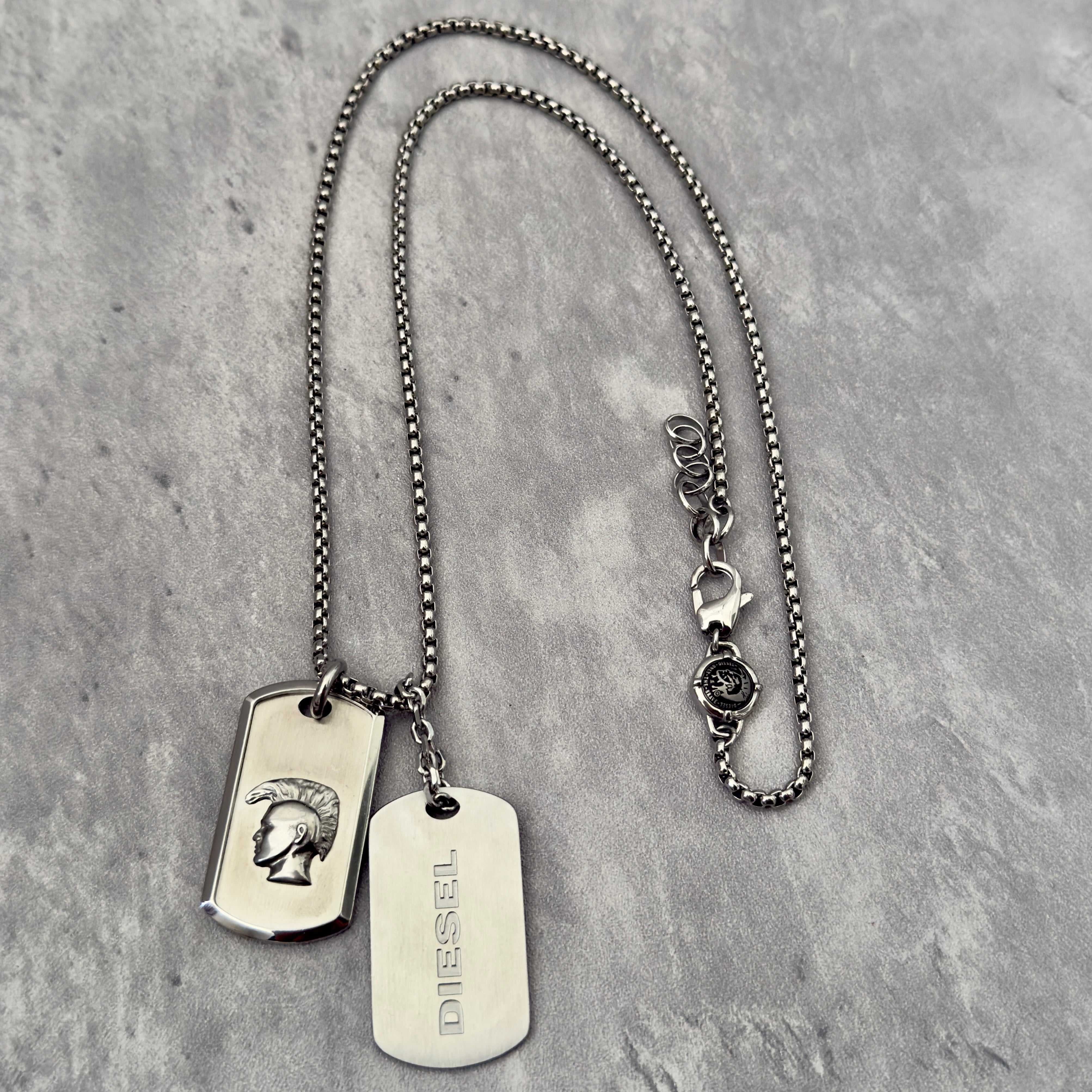 Diesel Double Plate Dog Tag Pendant Necklace in silver-tone stainless steel, featuring a Mohawk head engraving and Diesel logo.