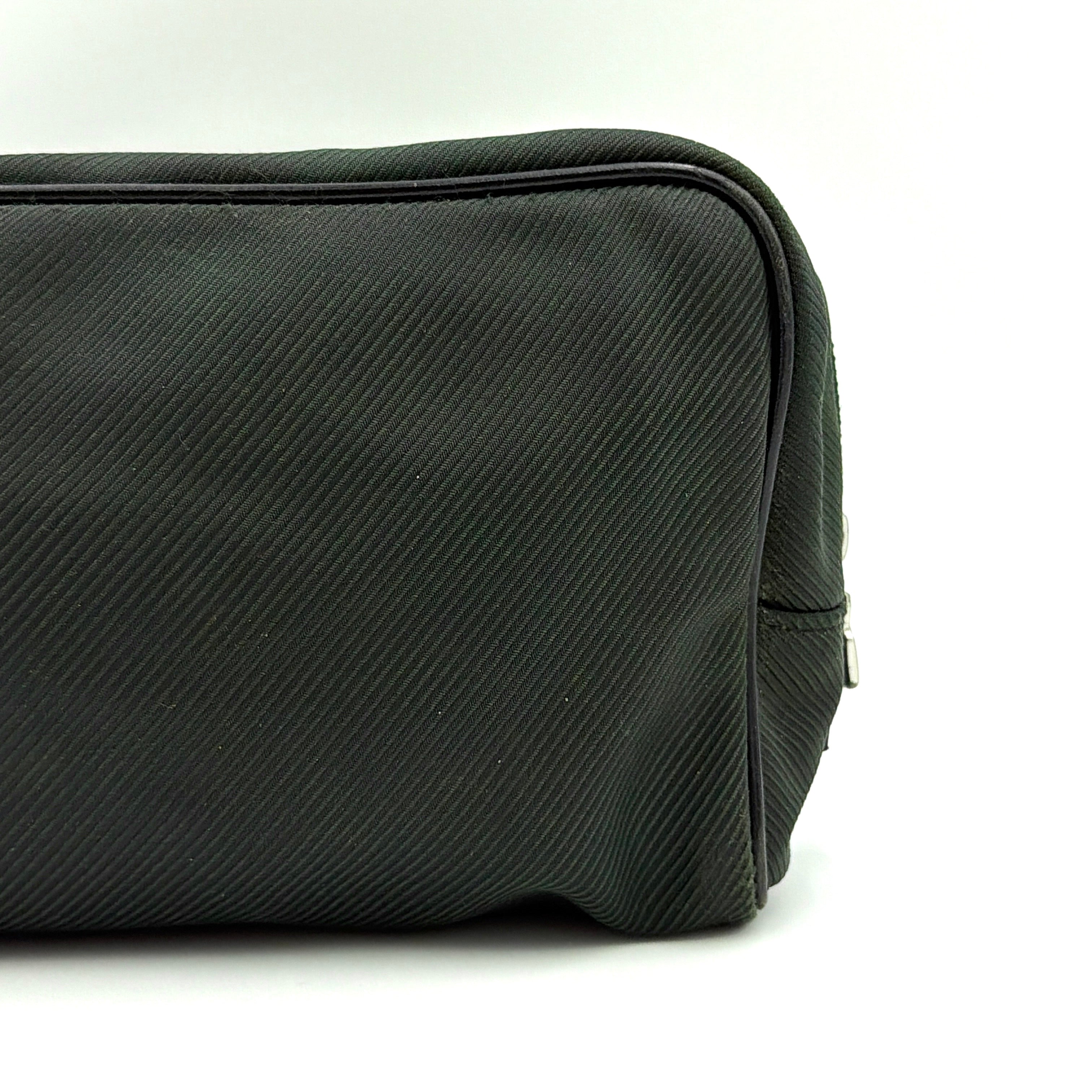 Louis Vuitton Taiga Parana Clutch Bag in deep green Taiga leather with black leather handle and silver-tone zipper, shown from the front.