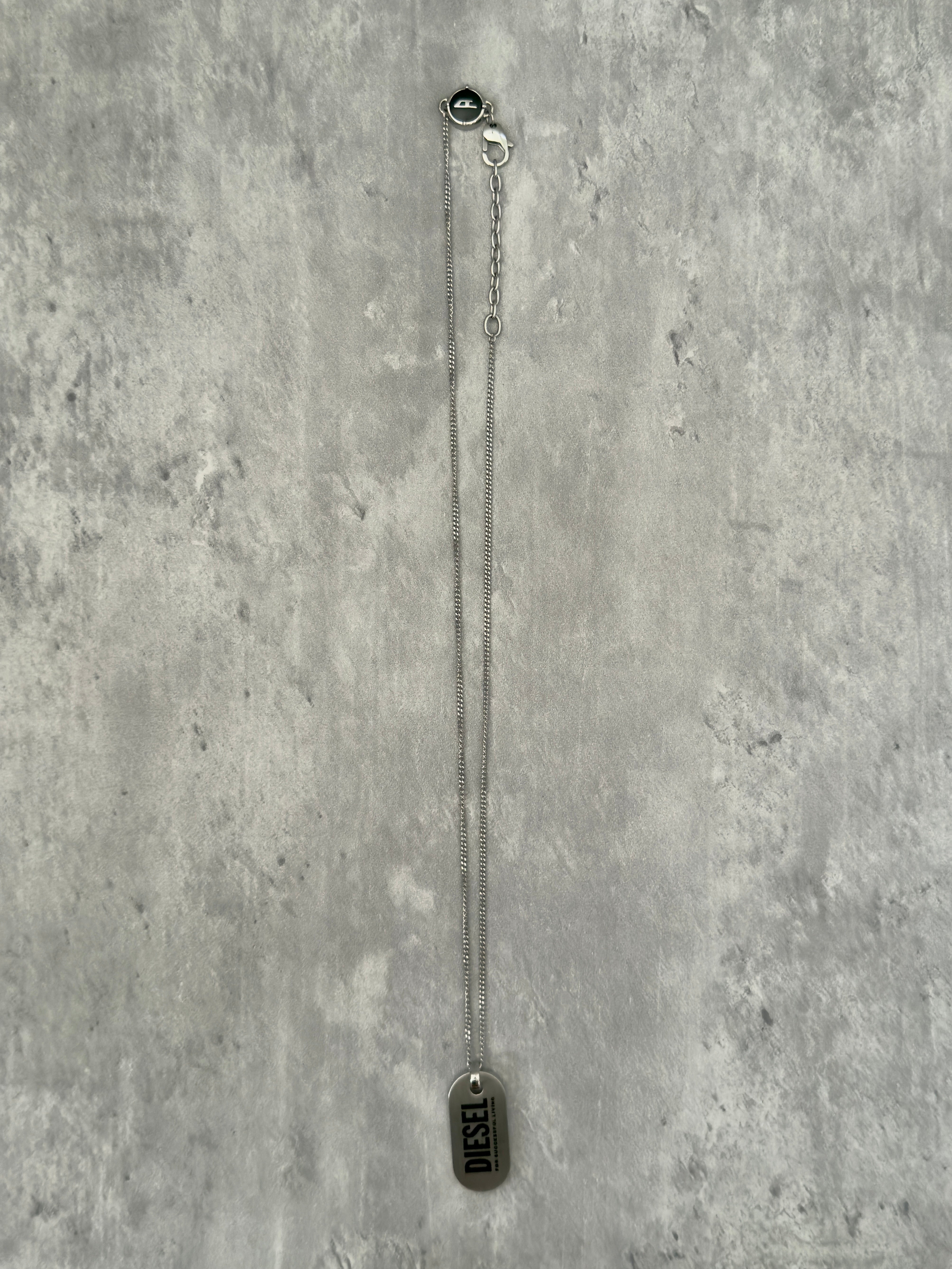 Diesel Signature 'For Successful Living' Dog Tag Necklace in stainless steel, featuring a brushed metal pendant and fine box chain.