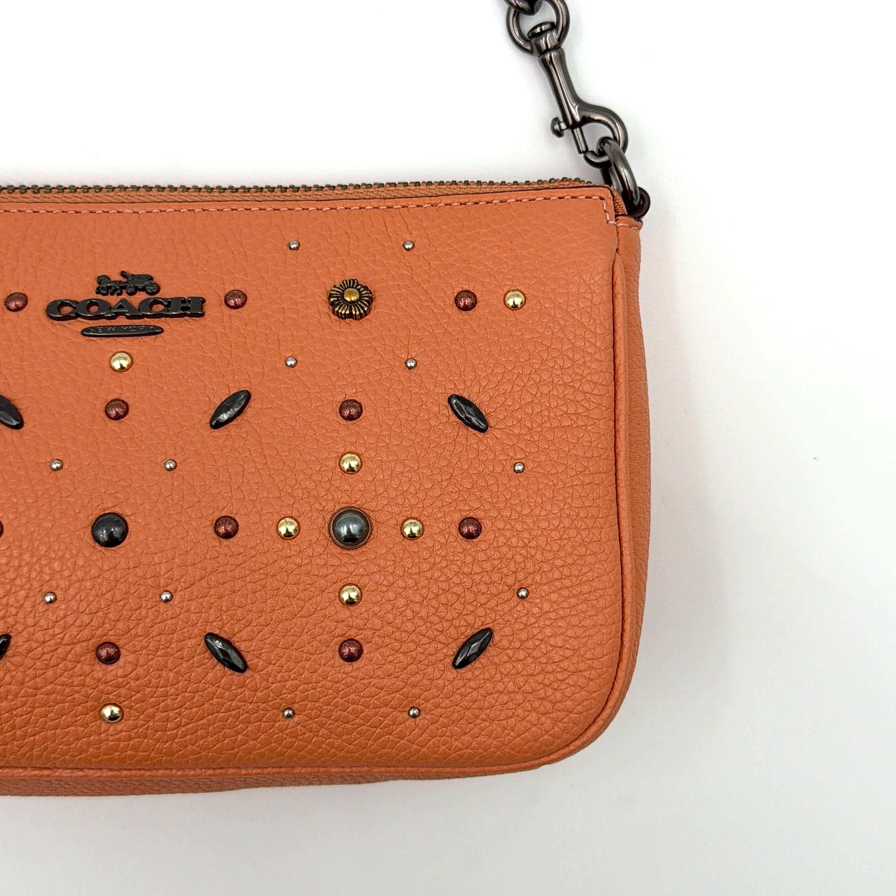 Coach Nolita 19 Prairie Rivets Shoulder Bag in bold orange pebbled leather with mixed metal rivet embellishments and chunky chain strap.