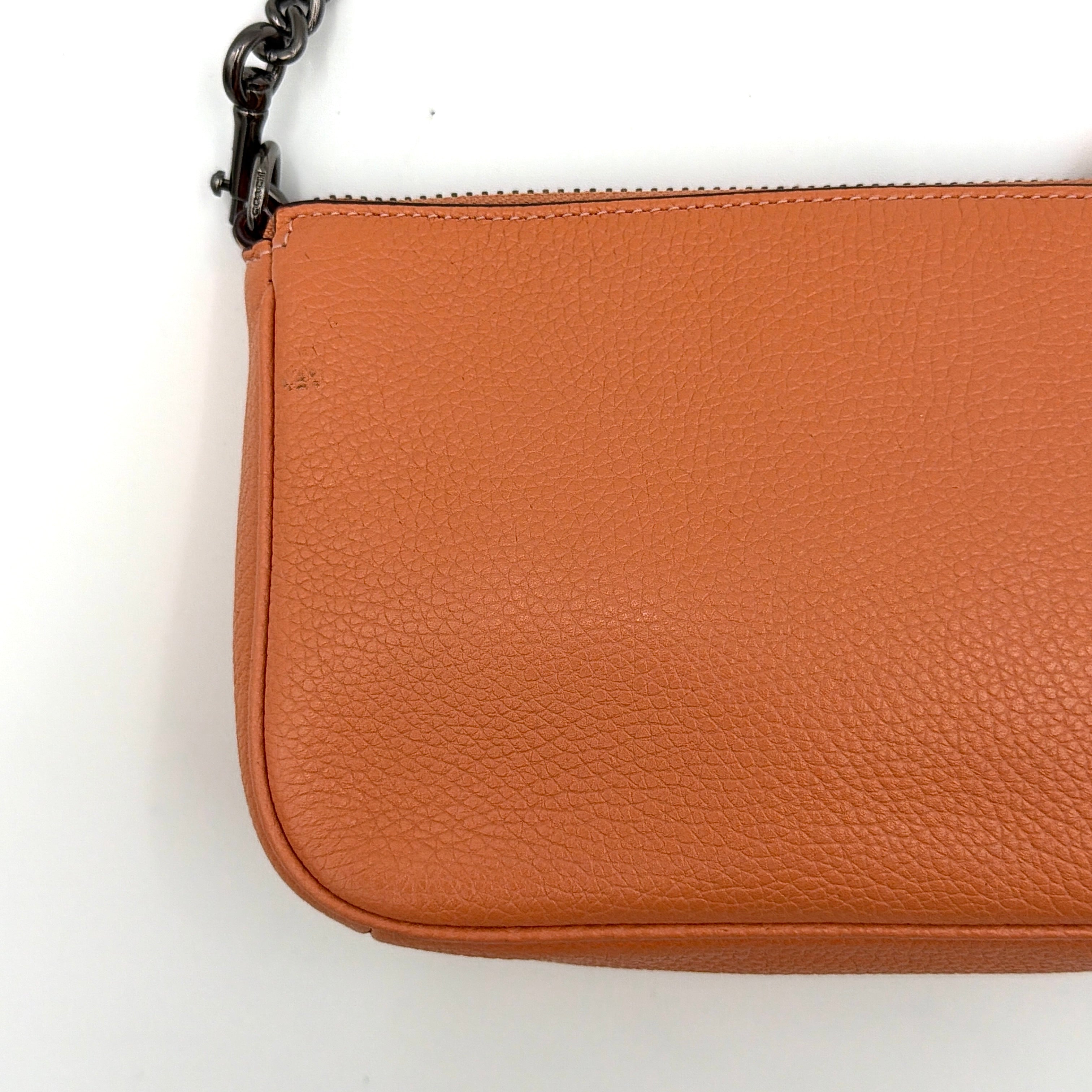 Coach Nolita 19 Prairie Rivets Shoulder Bag in bold orange pebbled leather with mixed metal rivet embellishments and chunky chain strap.