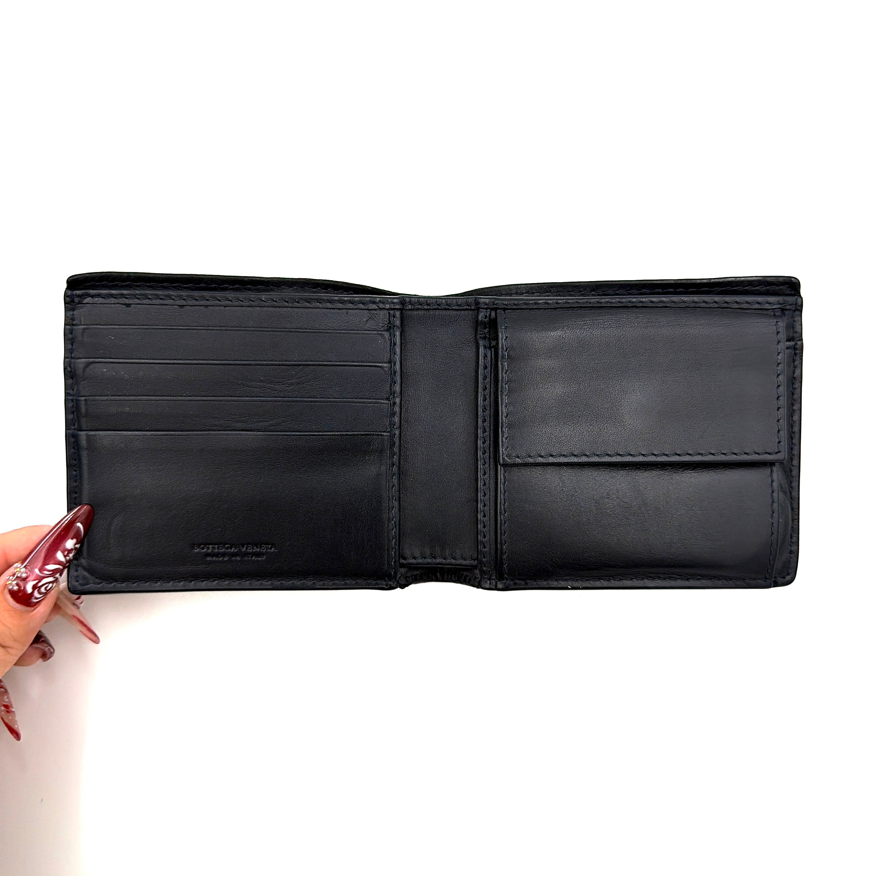 Black Bottega Veneta Intrecciato leather wallet with signature woven pattern photographed against a clean background.