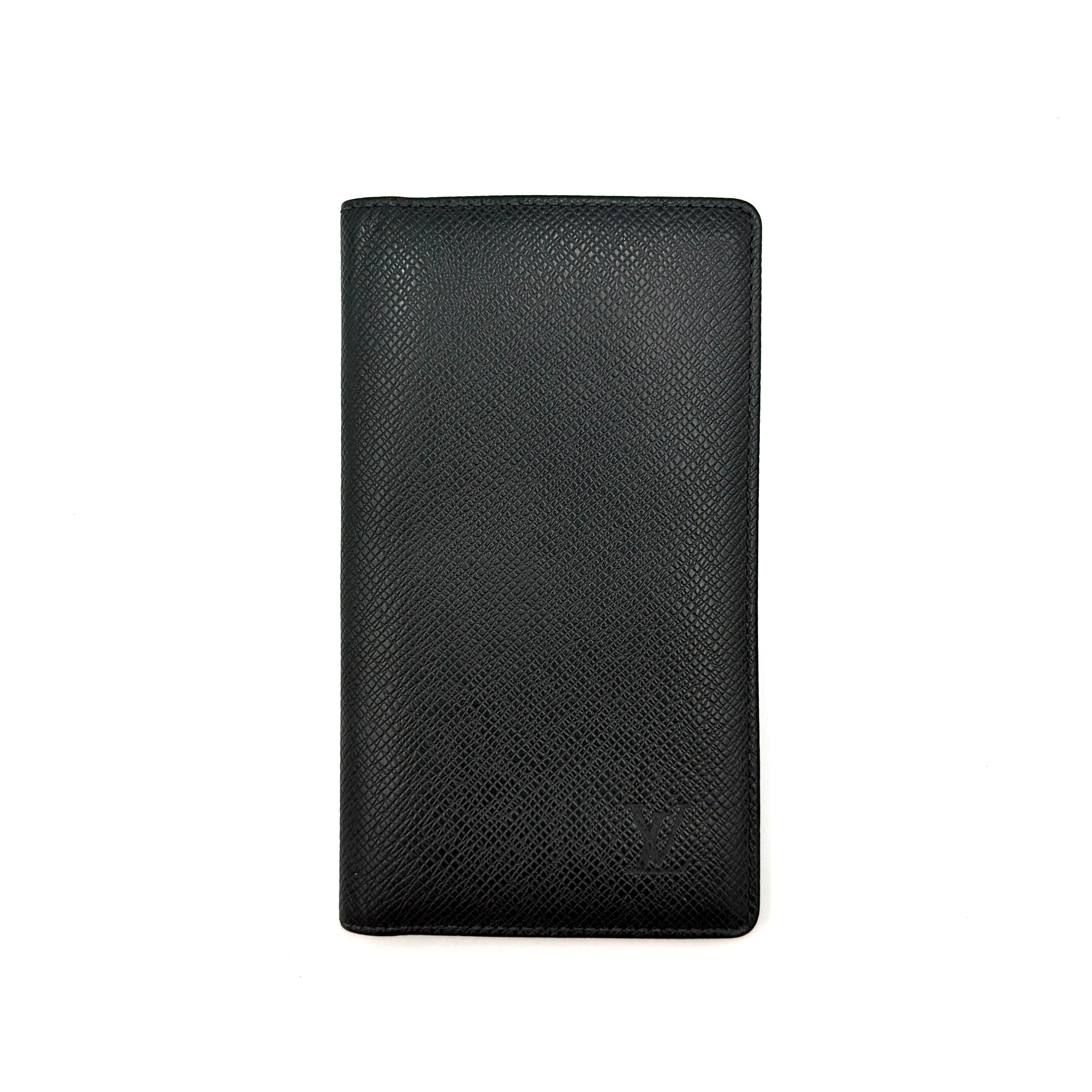 A Louis Vuitton Taiga Brazza Wallet in dark green, showcasing fine cross-grain leather texture and the understated LV monogram debossed on the front.