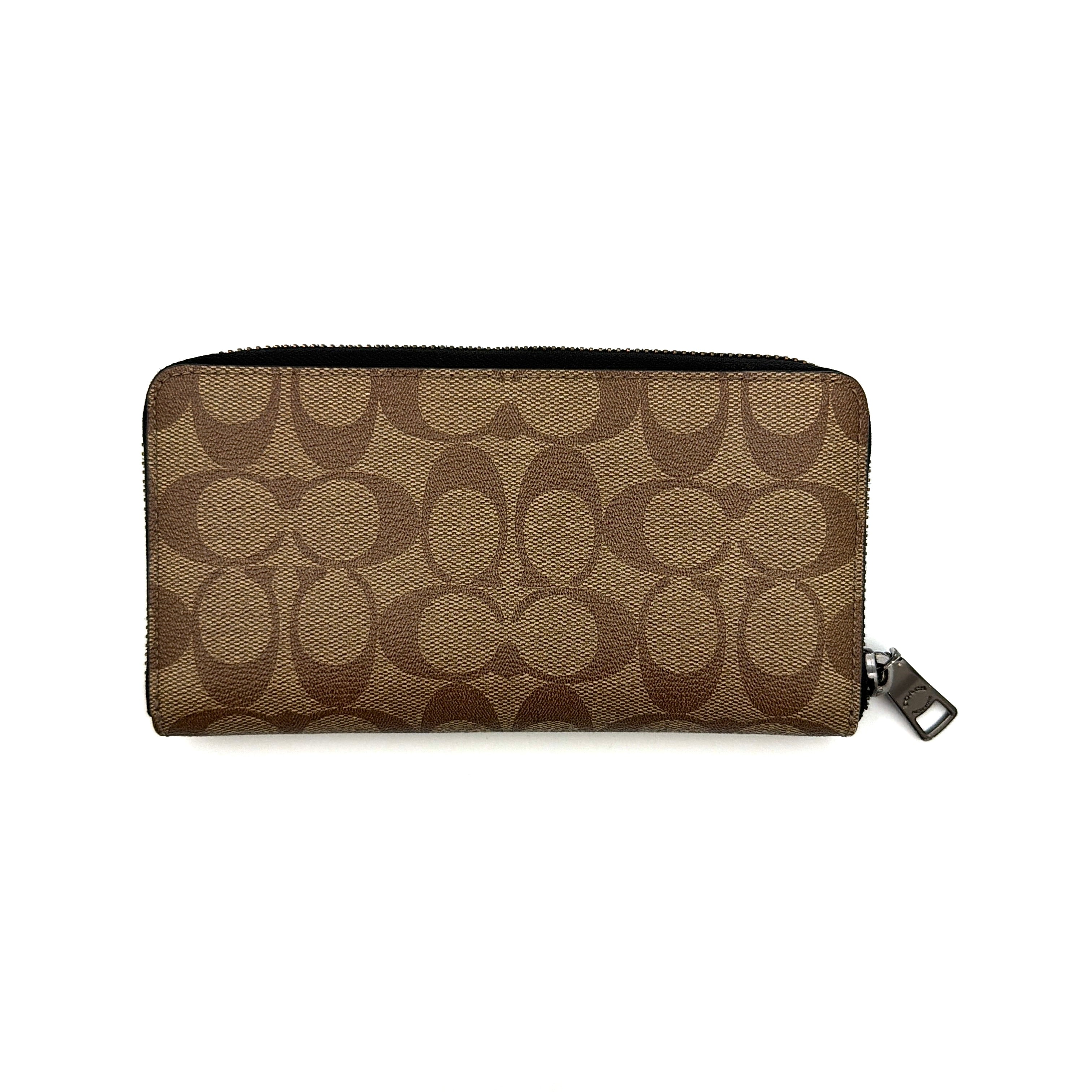 Coach Signature Accordion Long Wallet in beige and black canvas with black leather trim, featuring zip-around closure.