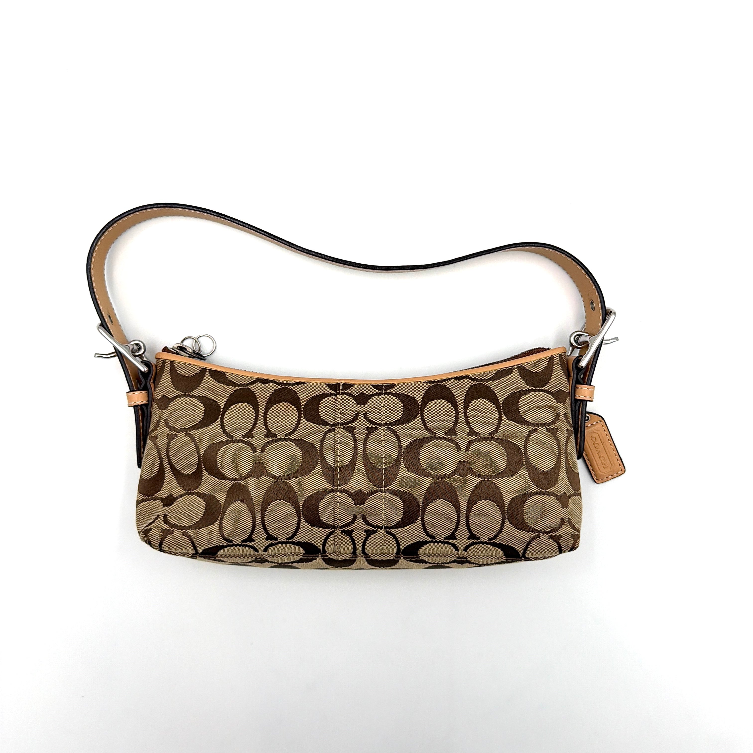 Coach Hamptons Demi Baguette shoulder bag in beige monogram canvas with tan leather trim and silver hardware.