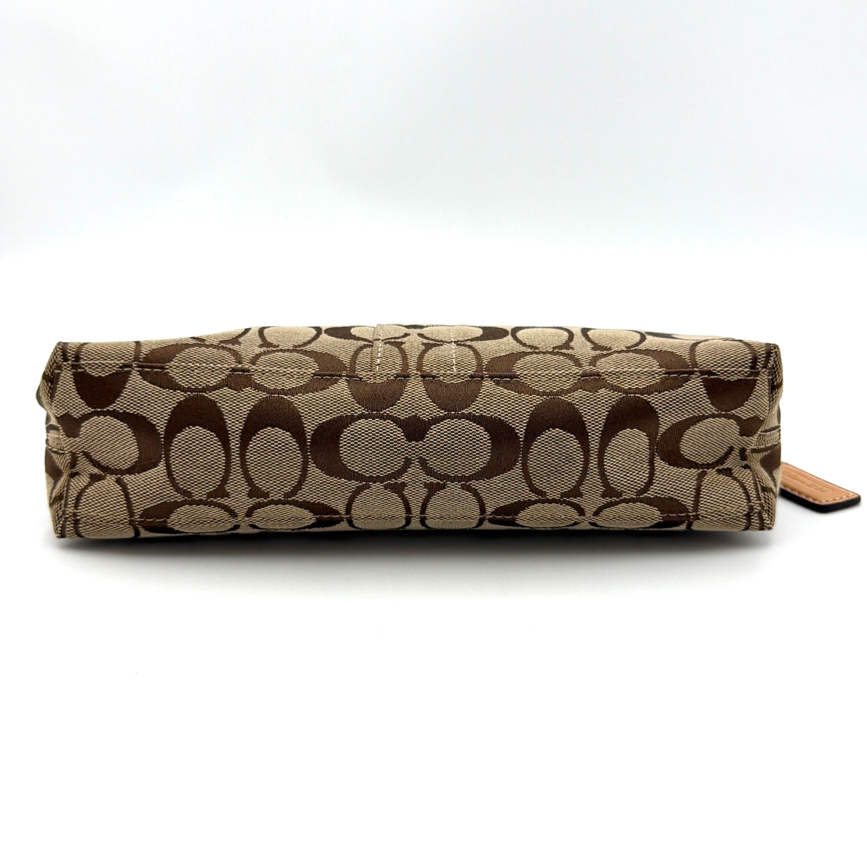Coach Hamptons Demi Baguette shoulder bag in beige monogram canvas with tan leather trim and silver hardware.