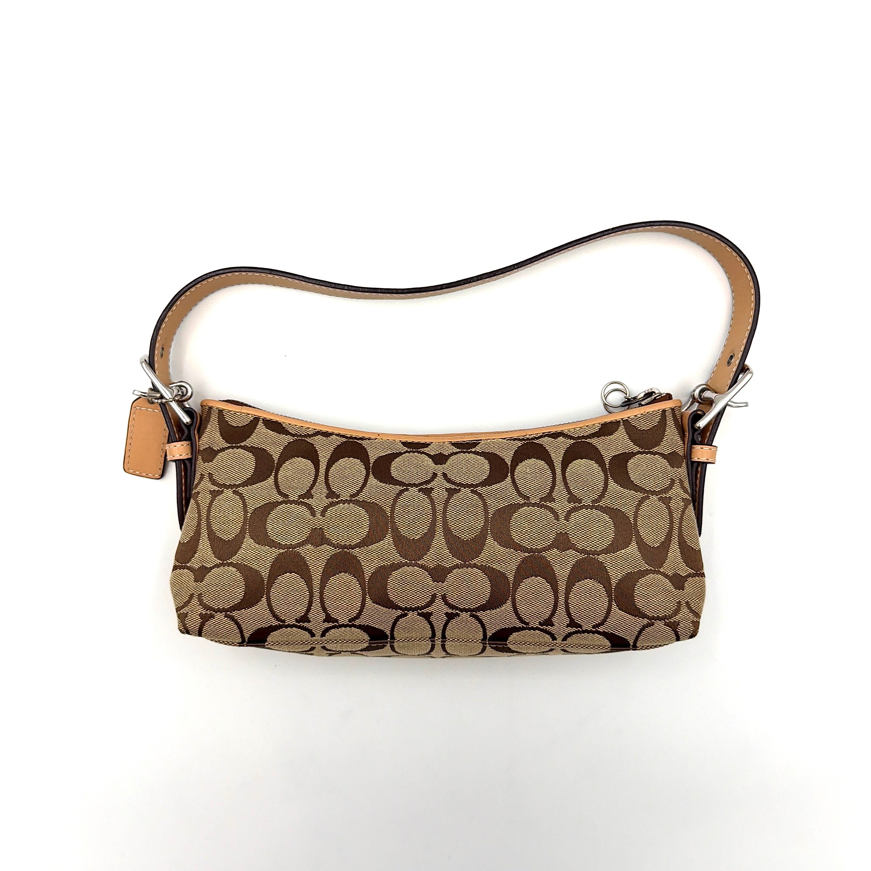 Coach Hamptons Demi Baguette shoulder bag in beige monogram canvas with tan leather trim and silver hardware.