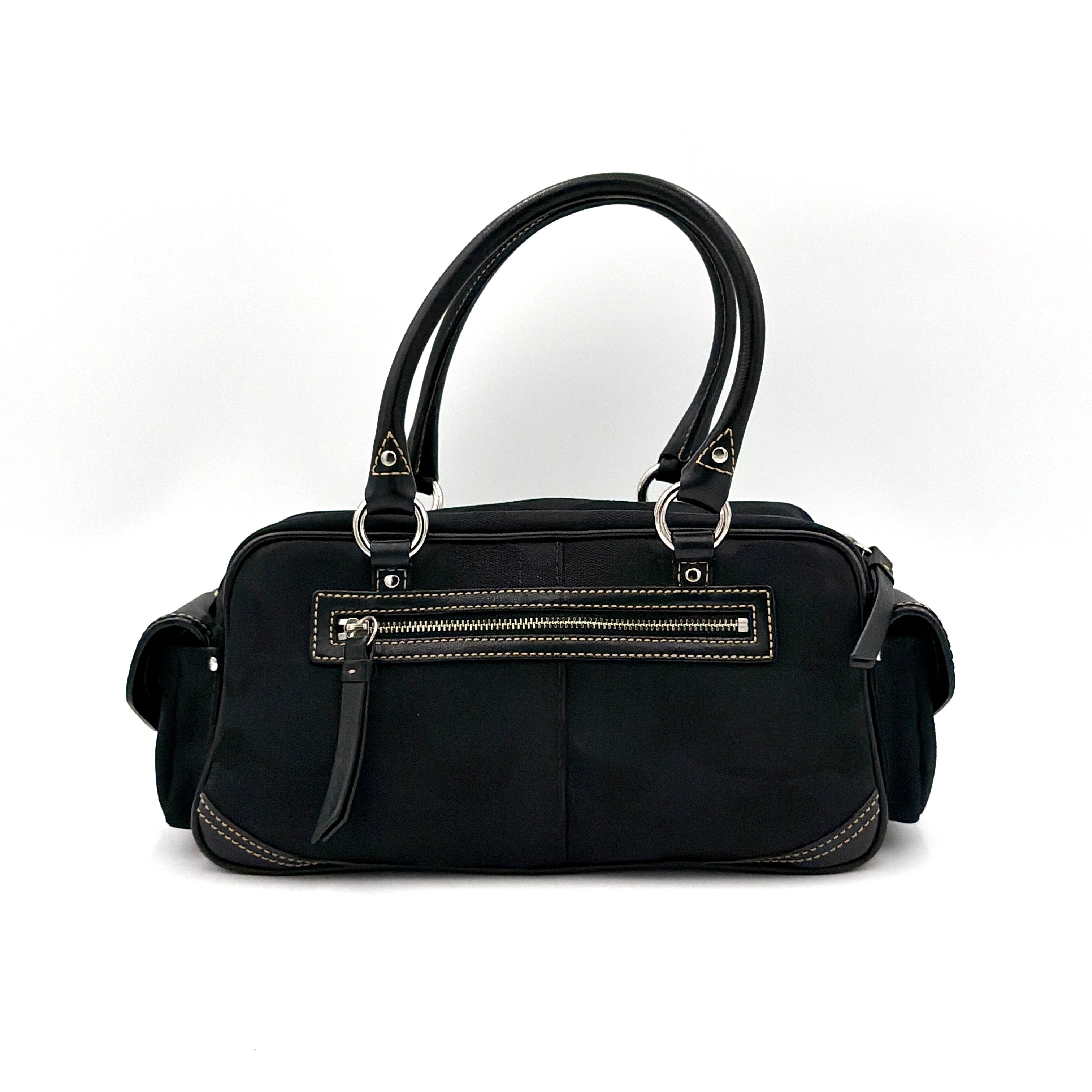 Coach black Signature Gallery satchel with double handles and silver hardware, set against a clean background.