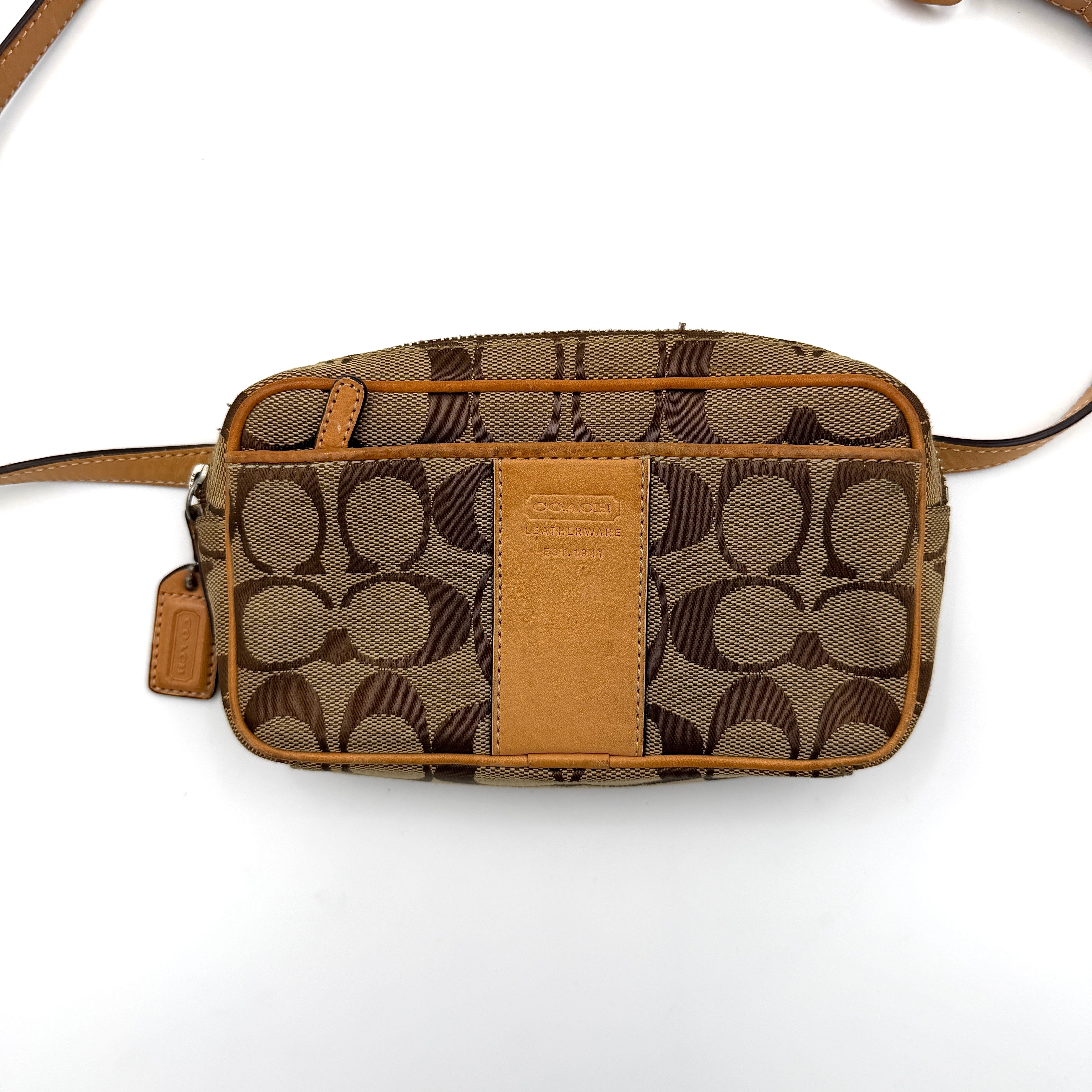 Coach Signature Canvas crossbody bag in beige and tan with iconic 'C' motif, natural leather trim and adjustable strap.