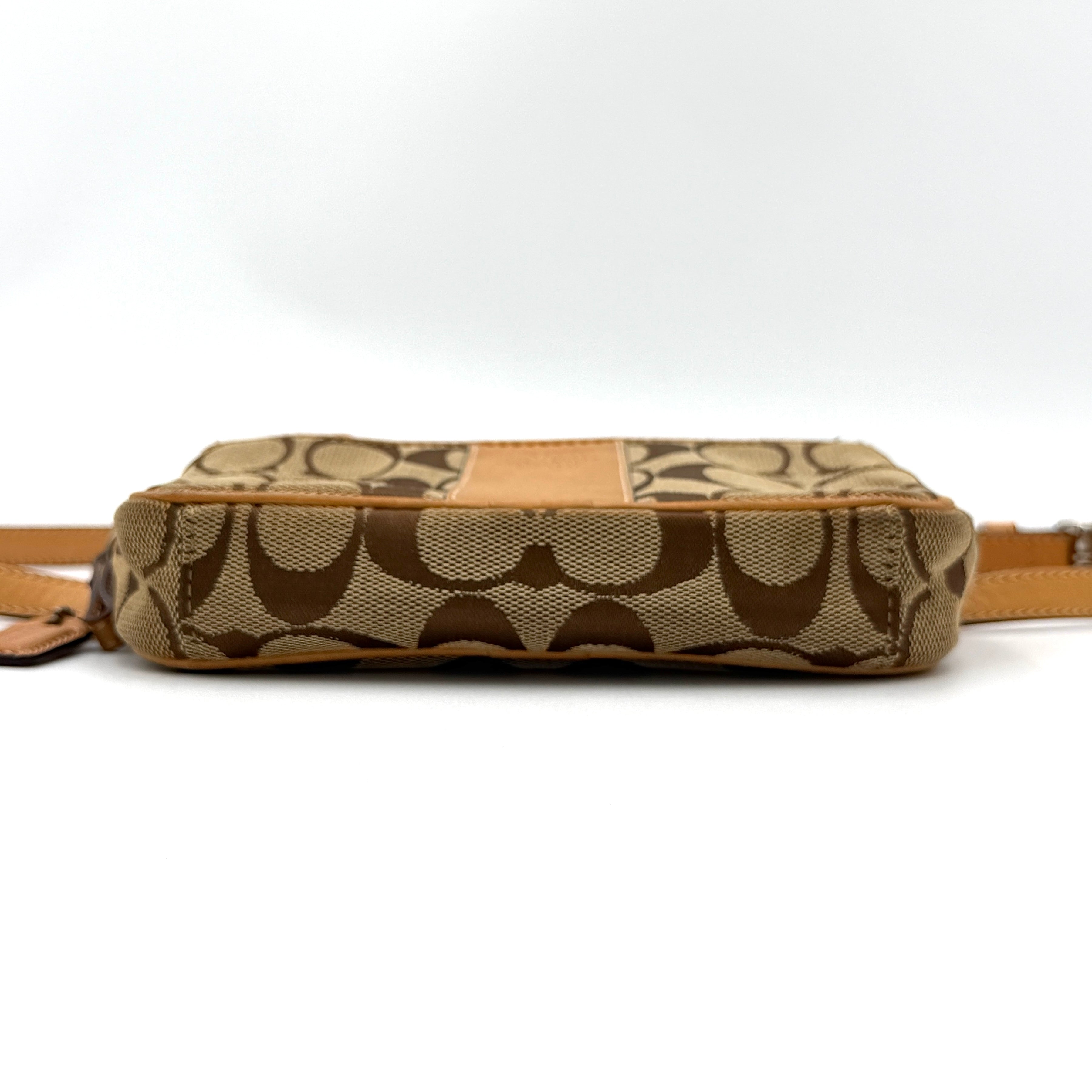 Coach Signature Canvas crossbody bag in beige and tan with iconic 'C' motif, natural leather trim and adjustable strap.