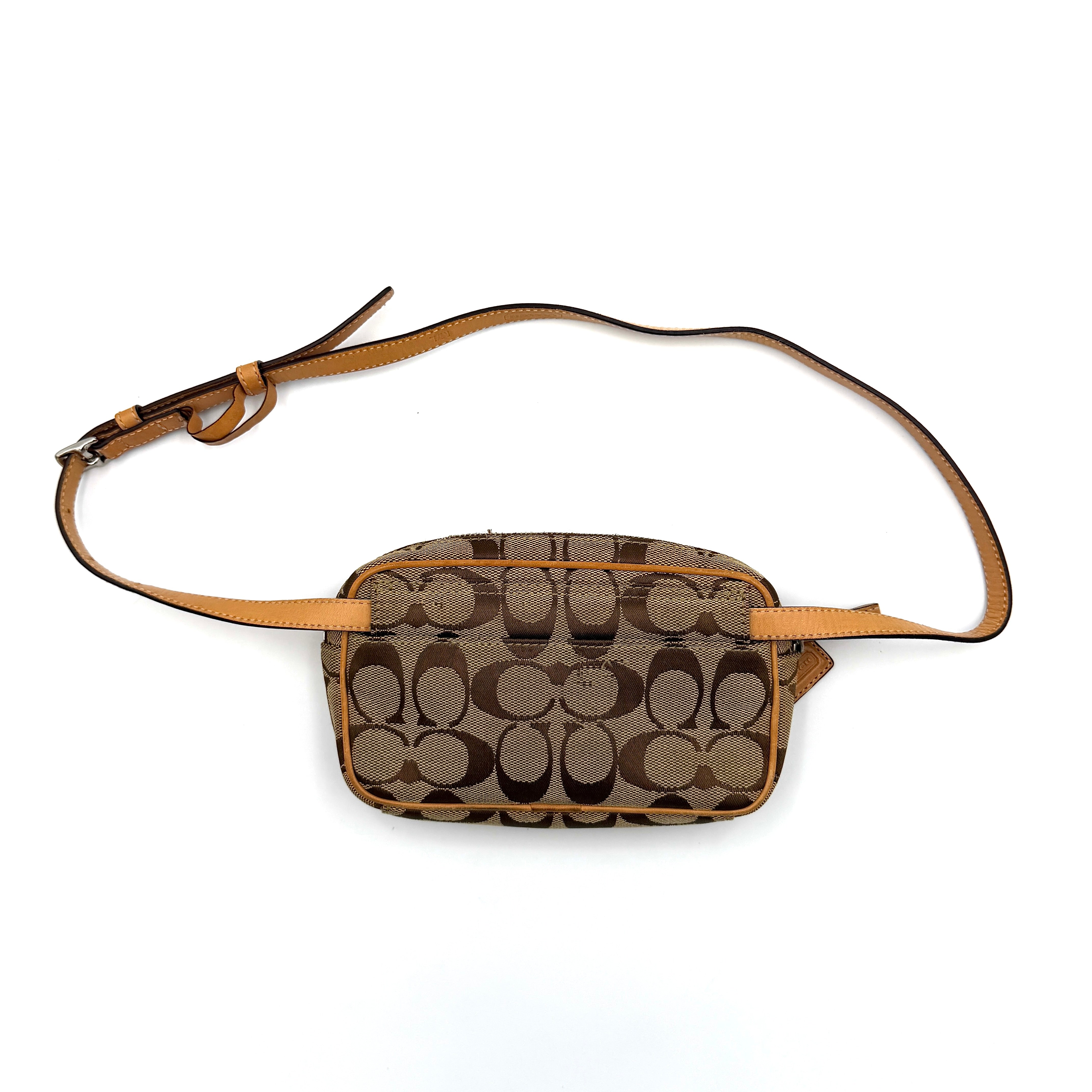 Coach Signature Canvas crossbody bag in beige and tan with iconic 'C' motif, natural leather trim and adjustable strap.