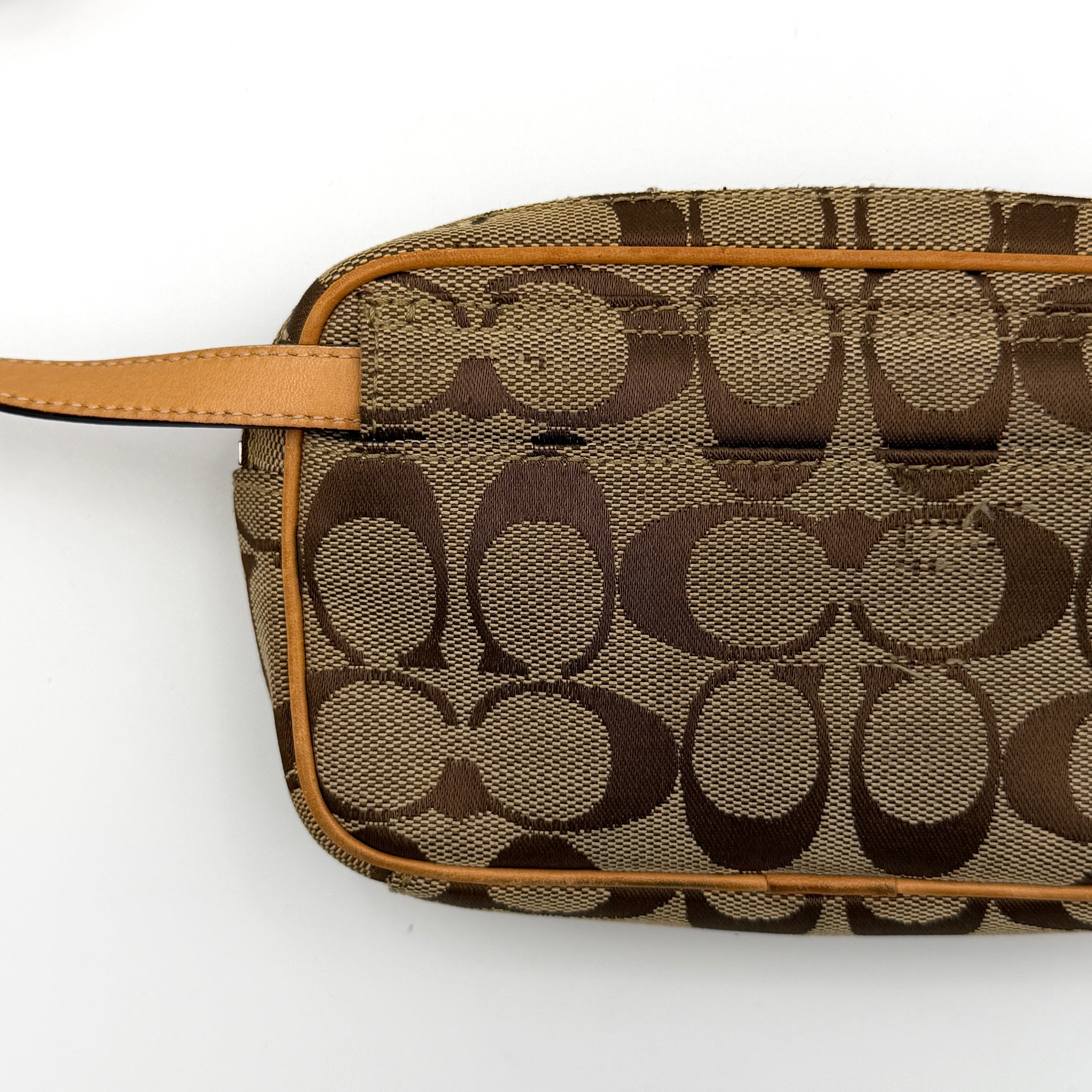 Coach Signature Canvas crossbody bag in beige and tan with iconic 'C' motif, natural leather trim and adjustable strap.