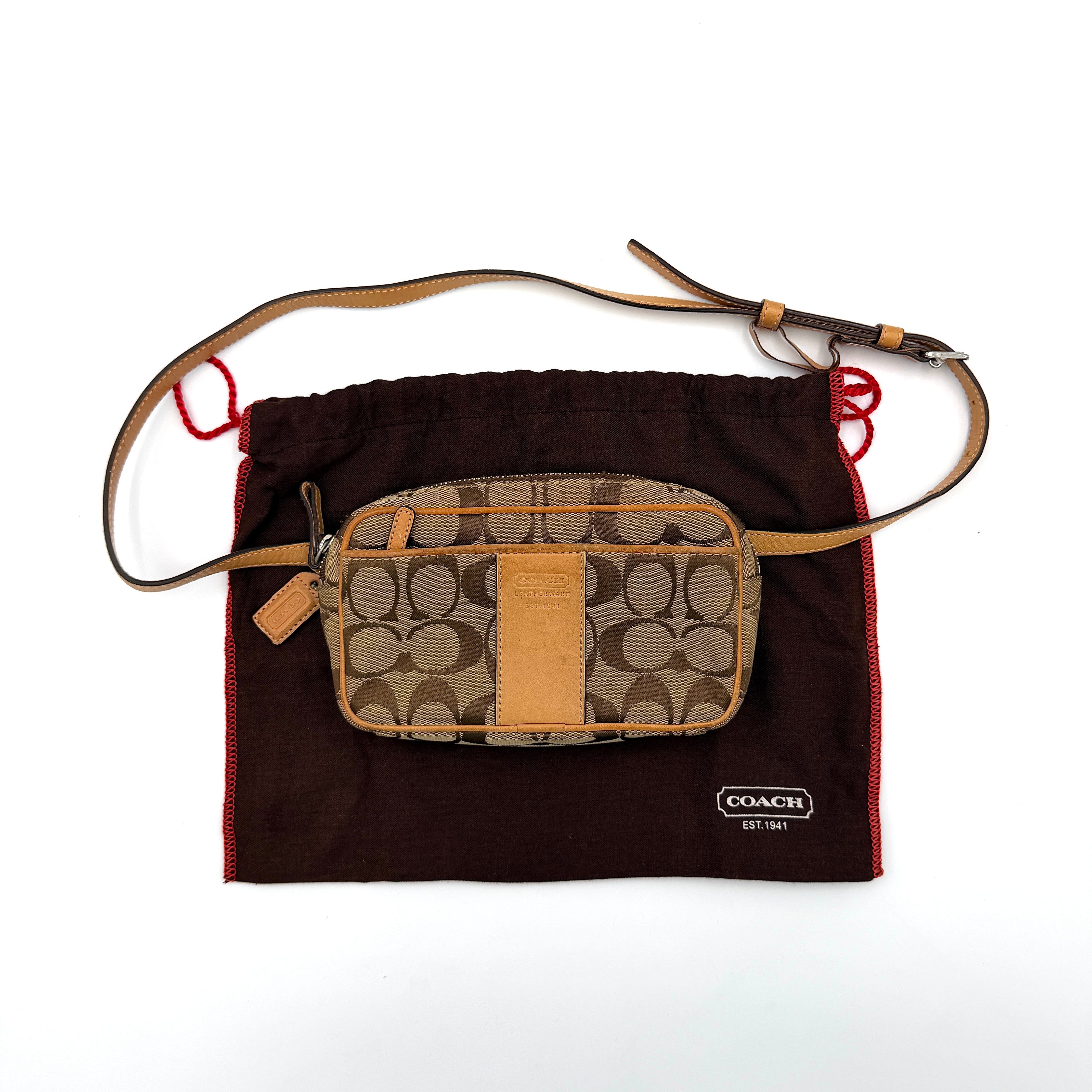 Coach Signature Canvas crossbody bag in beige and tan with iconic 'C' motif, natural leather trim and adjustable strap.