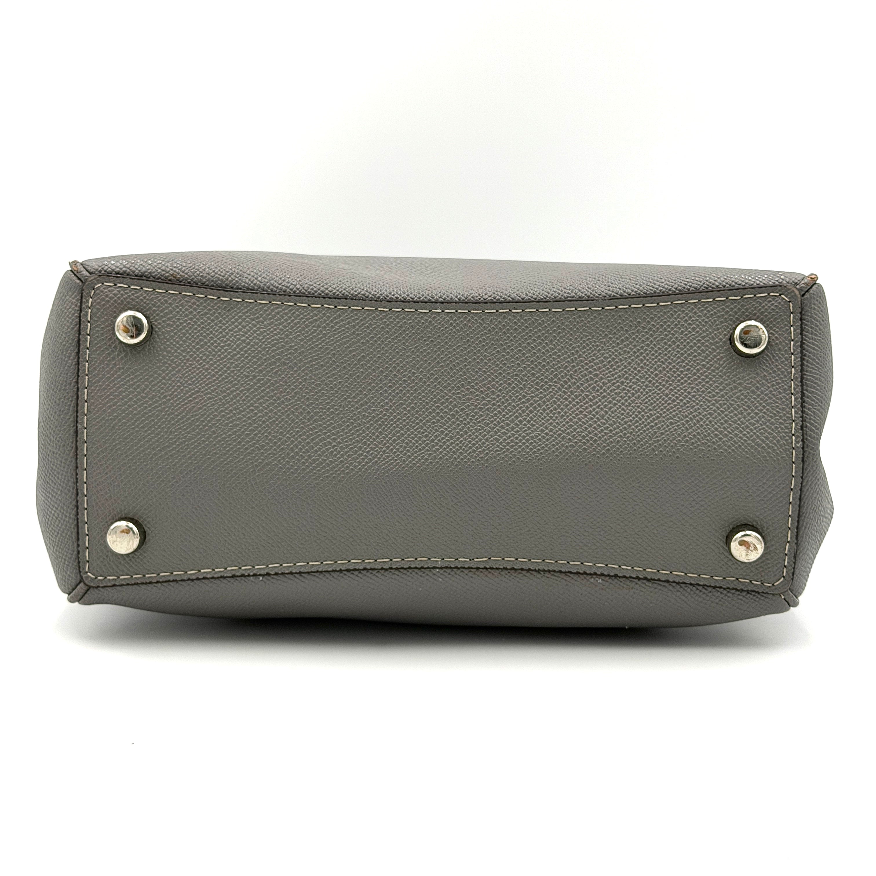 Coach 2Way Mini Surrey Carryall Handbag in grey textured leather with top handles and detachable strap, styled against a clean background.