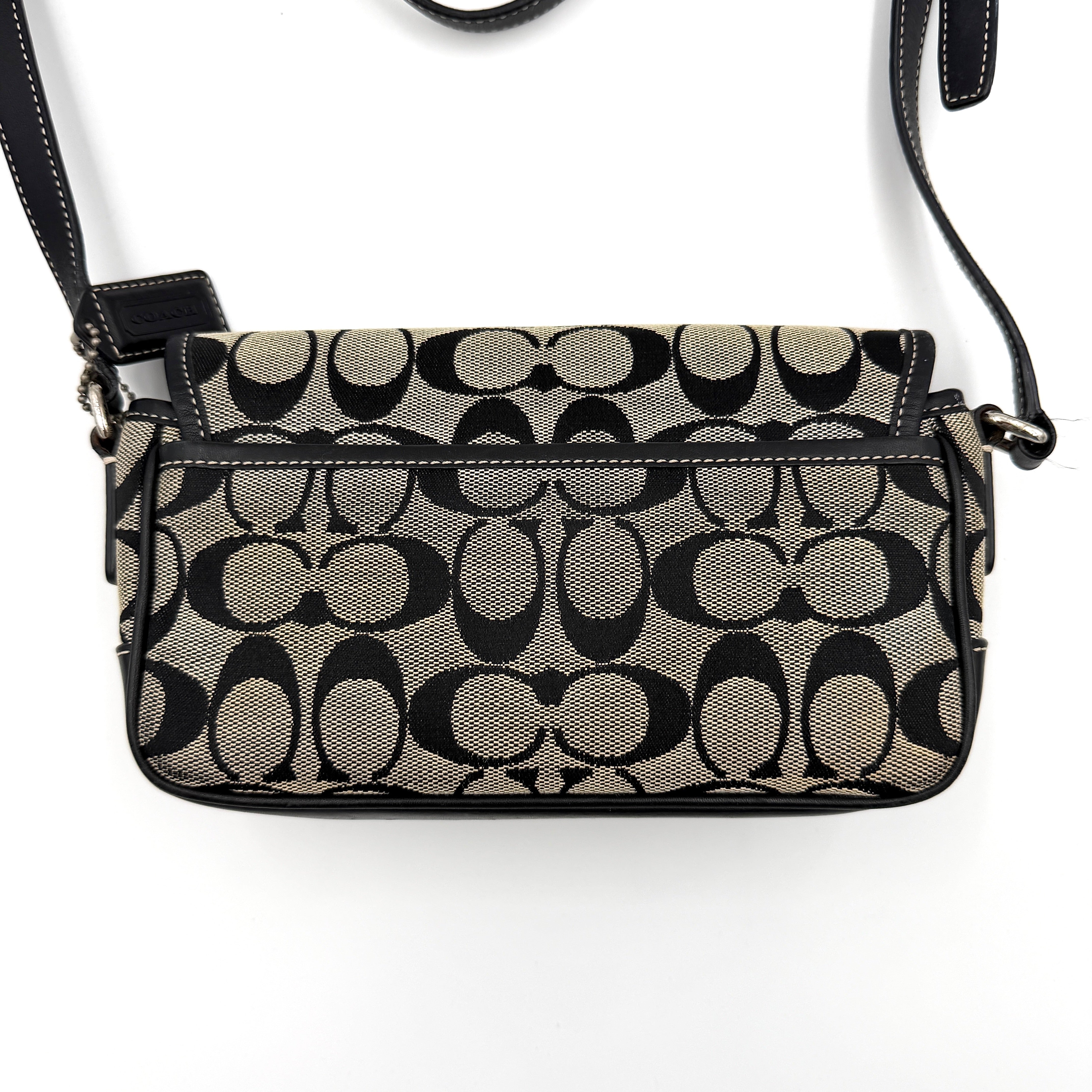 Coach Signature Double Buckle Crossbody bag in grey and black jacquard canvas, accented with black leather trim and dual silver-tone buckle detailing.