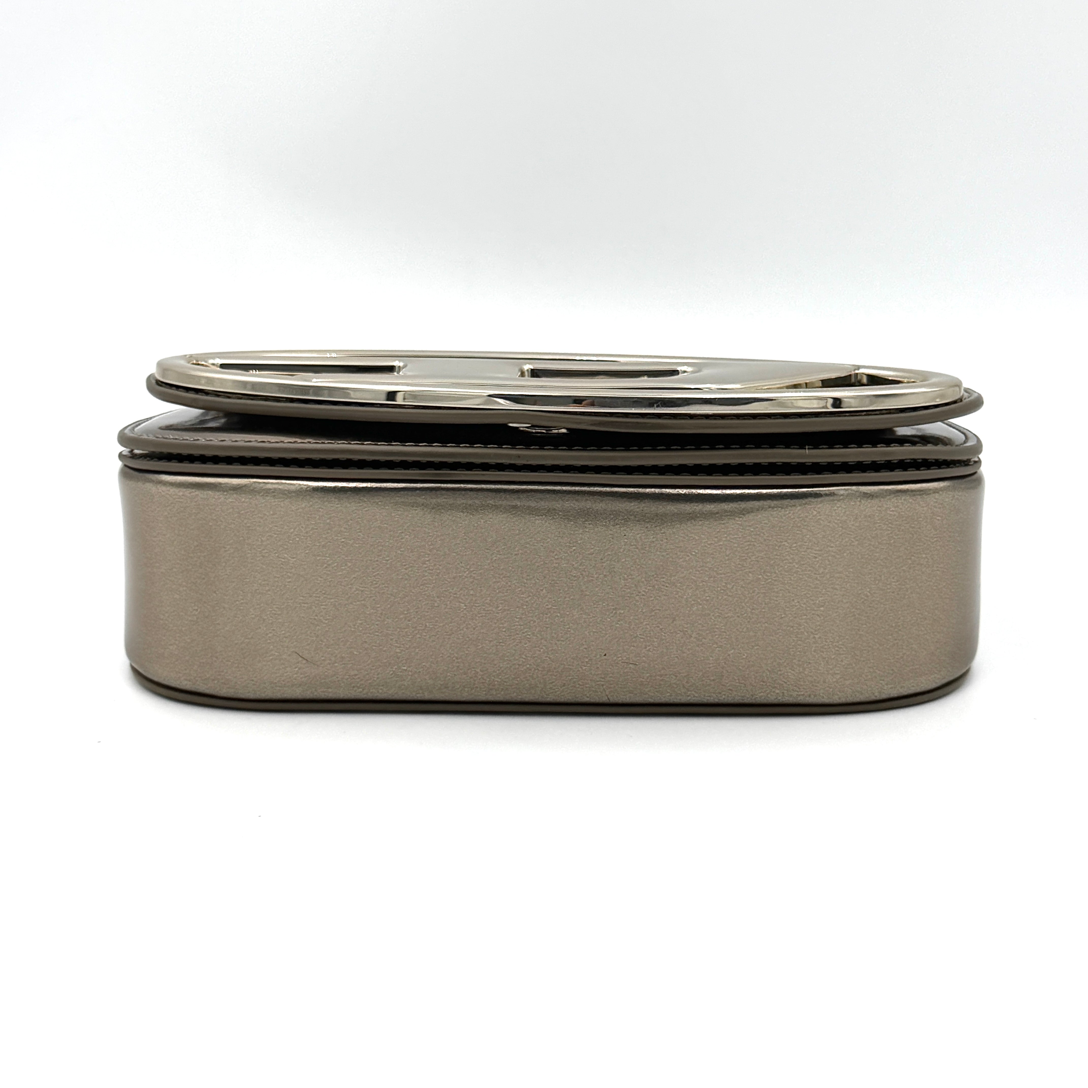 Diesel 1DR metallic silver shoulder bag with oversized chrome D-logo plaque, top handle, and detachable strap displayed against a white background.