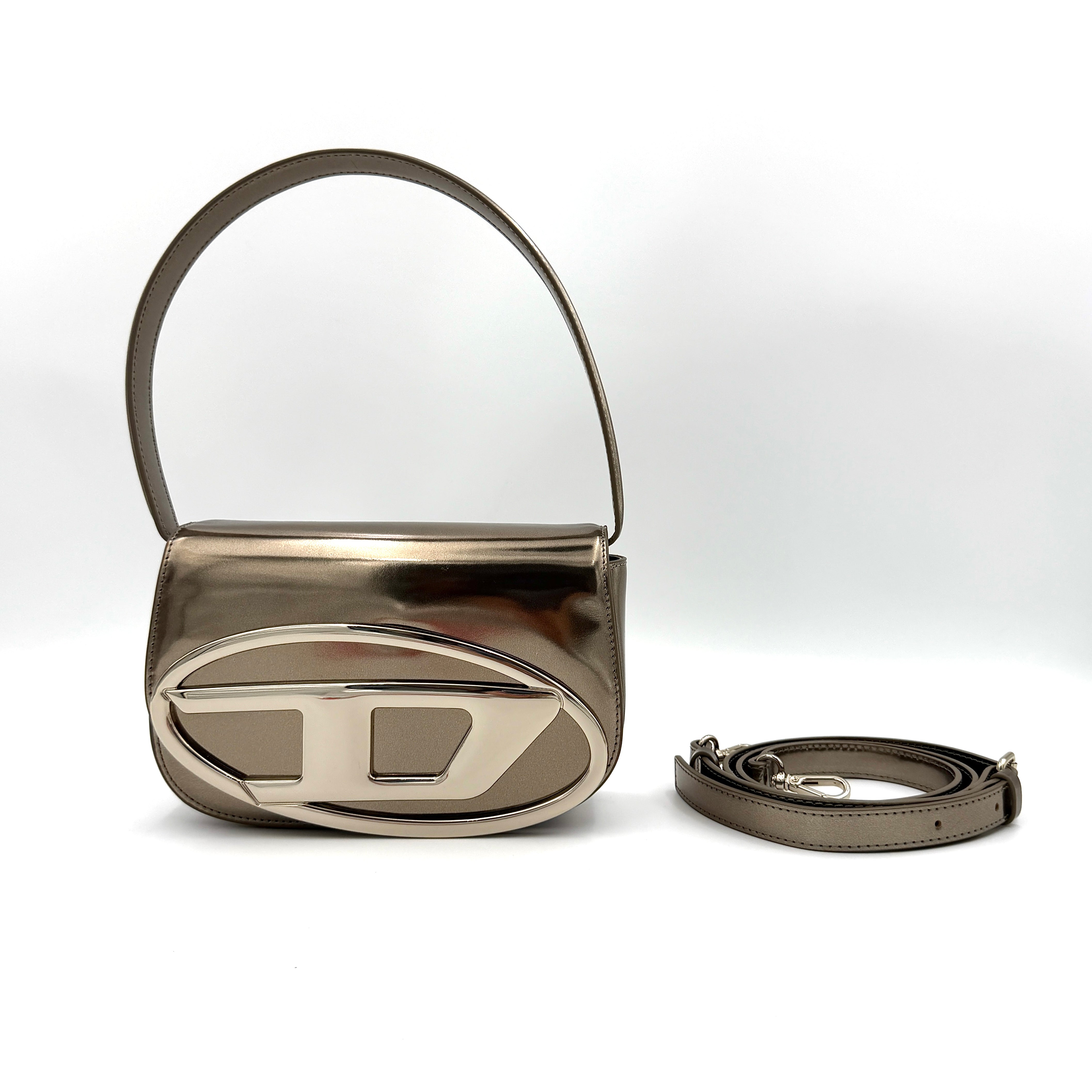 Diesel 1DR metallic silver shoulder bag with oversized chrome D-logo plaque, top handle, and detachable strap displayed against a white background.