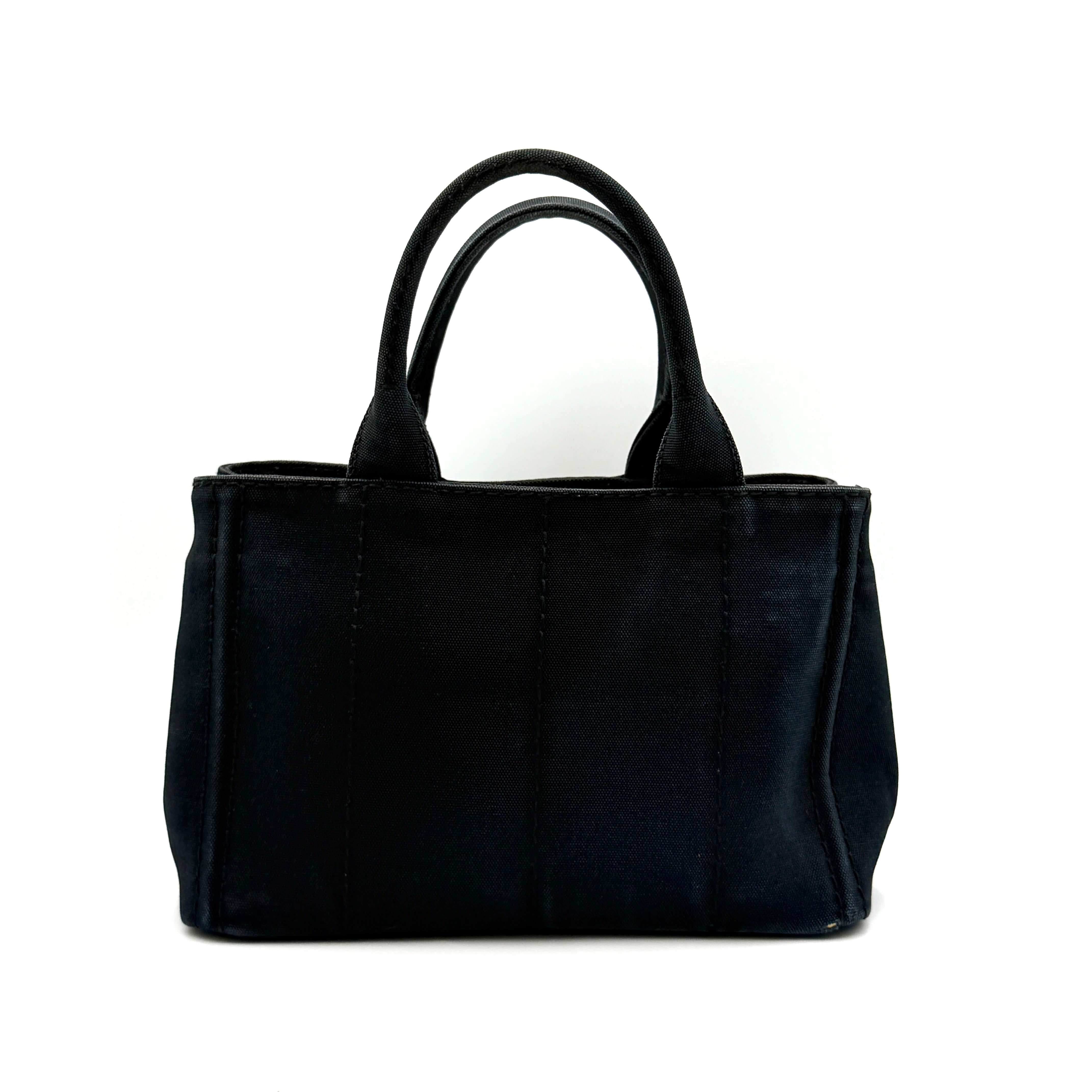 Front-facing Prada Canapa Embroidered Logo Tote in black canvas with ivory stitched logo and double handles.