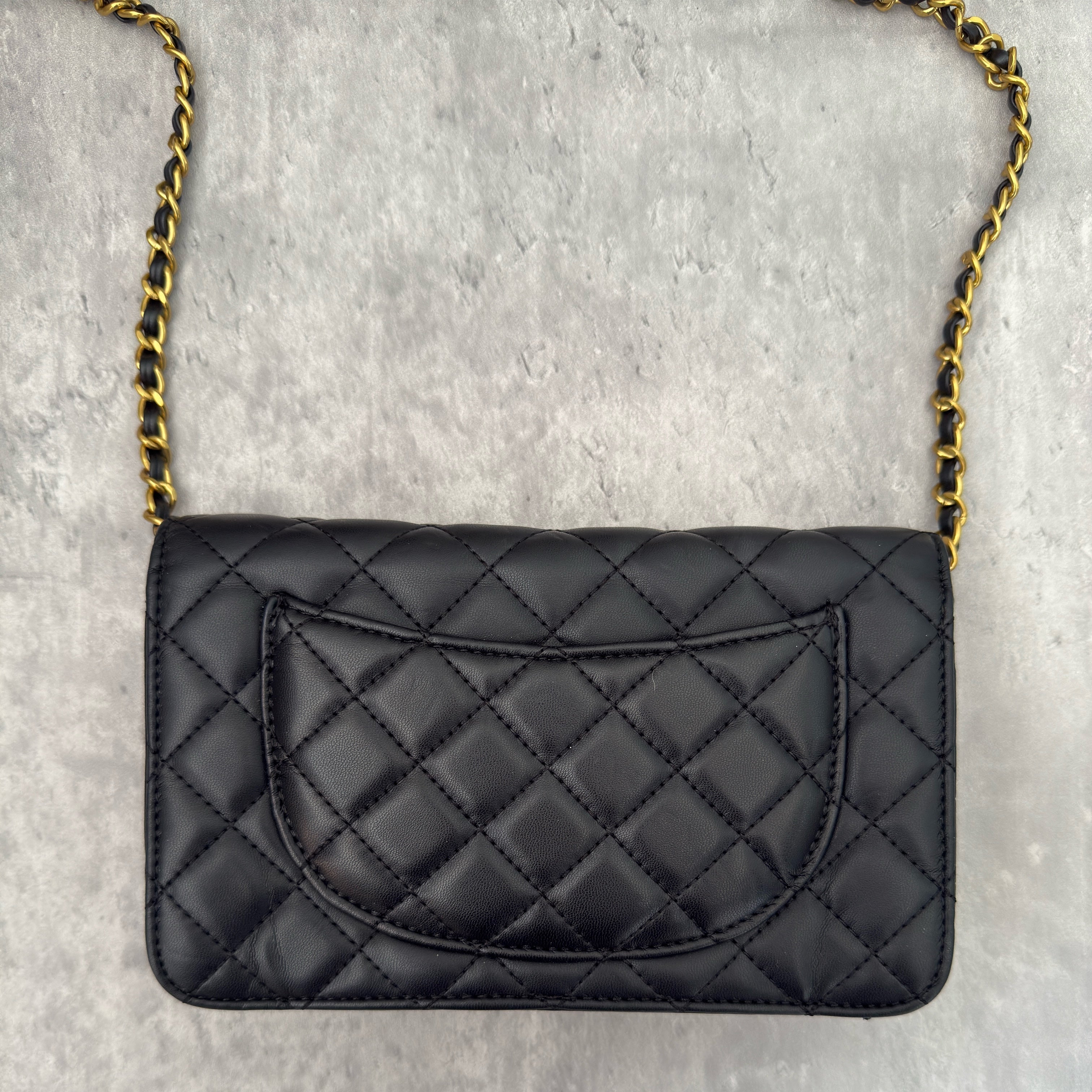 Charles & Keith Cressida Quilted Push-Lock Clutch Bag in black faux leather with gold-tone chain strap and secure push-lock closure.